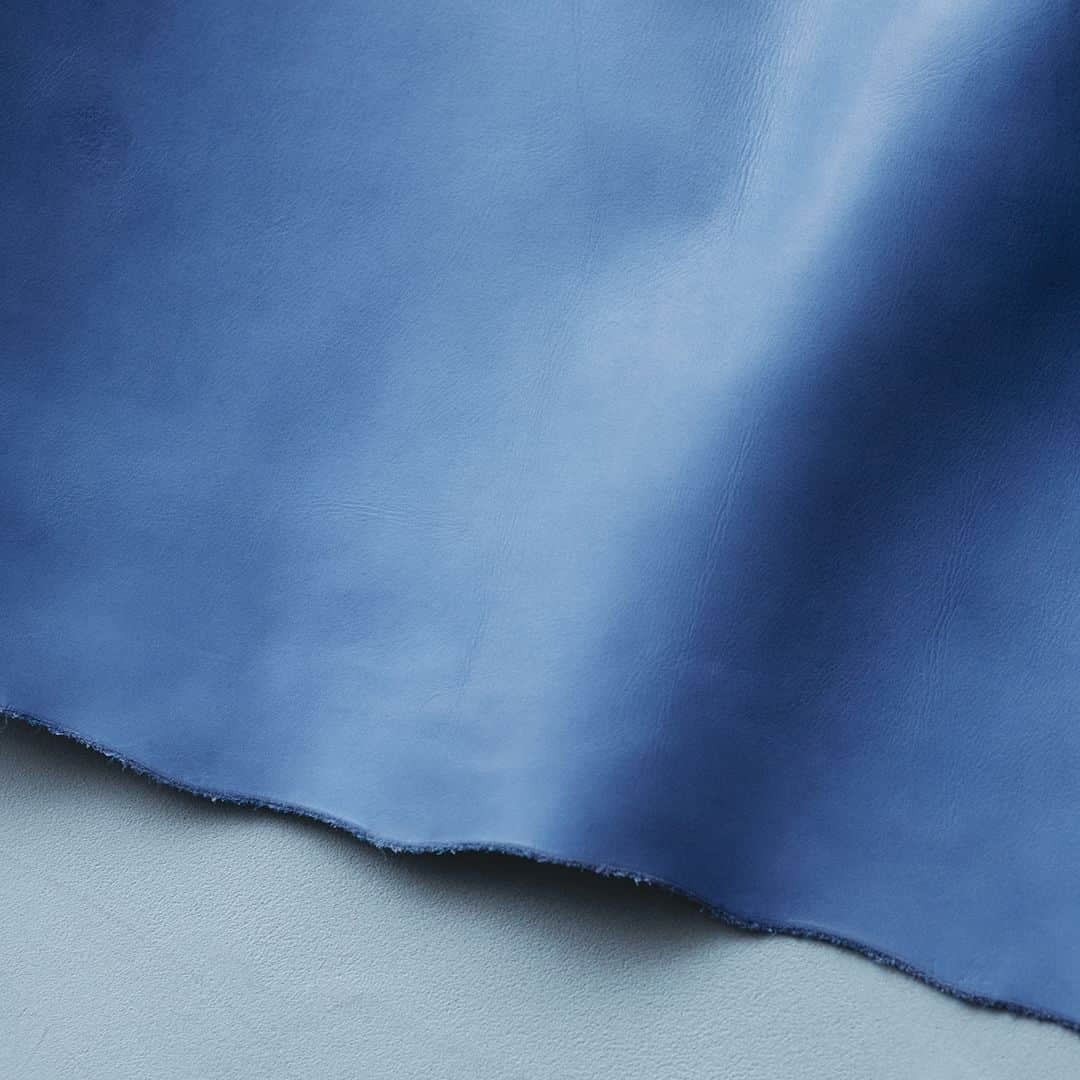 土屋鞄さんのインスタグラム写真 - (土屋鞄Instagram)「8/3（木）に発売する「JAPANMOTIF Ai」コレクションは、天然のインド藍と合成藍で染め上げ、オイルを加えて柔らかく仕上げた「牛革（藍染）」を採用しています。  2度のクロム鞣しの後、素上げの状態のまま藍染を施し、豊かな色合いへ。熟練の職人が革の状態を見極めながら5～6回に分けて少しずつ染め上げていきます。  こうして完成した素材は、革本来の風合いと表情の豊かさに、藍染の柔らかな色味が加わりました。使い込むほどつやが増し、柔らかくなじむ経年変化も楽しめます。  #JAPANMOTIFAi #土屋鞄 #革 #革製品 #革鞄 #トートバッグ #ハンドバッグ #ボディバッグ #革財布 #職人 #手仕事 #leather #leatherbag #totebag #craftsmanship #creativity #timeless #madeinjapan #TSUCHIYAKABAN」7月14日 19時00分 - tsuchiya_kaban