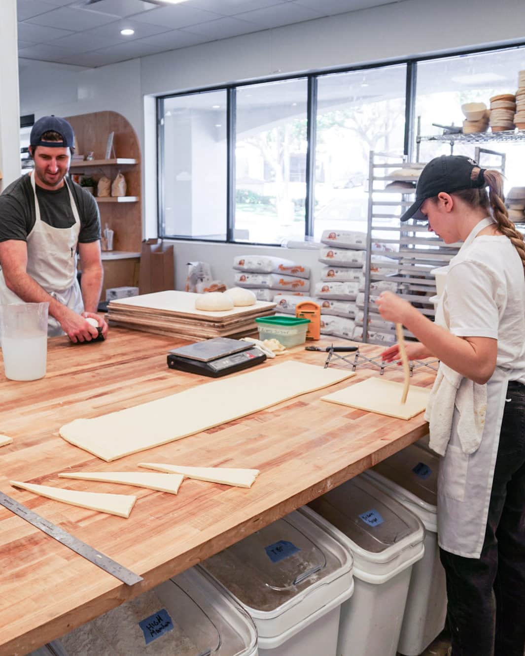 Eater LAさんのインスタグラム写真 - (Eater LAInstagram)「The day before its grand opening on July 13, Garrett McPerry shapes sourdough loaves with his head baker while his wife and partner Lauren Rosen coaches front-of-house staff on customer service. The lines are already stacking at Tommy & Atticus (@tommyandatticus), McPerry and Rosen’s yearslong journey to opening a full-fledged bakery in the South Bay, and the early results are already spectacular. Local dog walkers, curious passersby, and family friends are stoked with McPerry’s pastry case, chock-full of seasonal stone fruit and berry galettes, buttery croissants, crumbly cookies, and sugary kouign amann.  Click on the link in bio to read the opening of one of LA's best new bakeries, written by Eater LA lead editor Matthew Kang (@mattatouille).  📸: @mattatouille」7月15日 6時01分 - eater_la