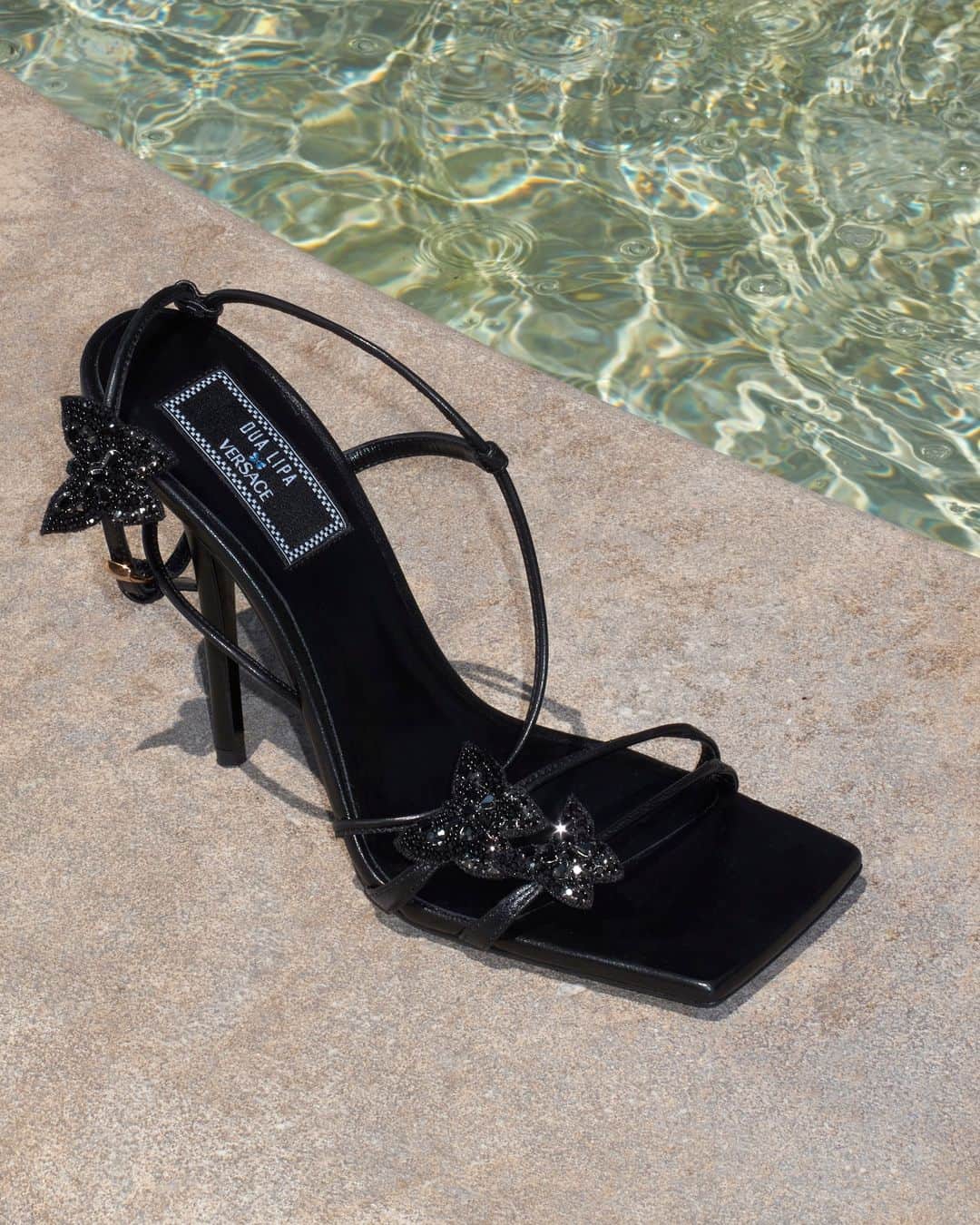 ジャンニヴェルサーチのインスタグラム：「Crystal Butterflies Sandals  Cannes, South of France.  Now at Versace.com via the link in bio.  #VersaceLaVacanza #VersaceLaMedusa」
