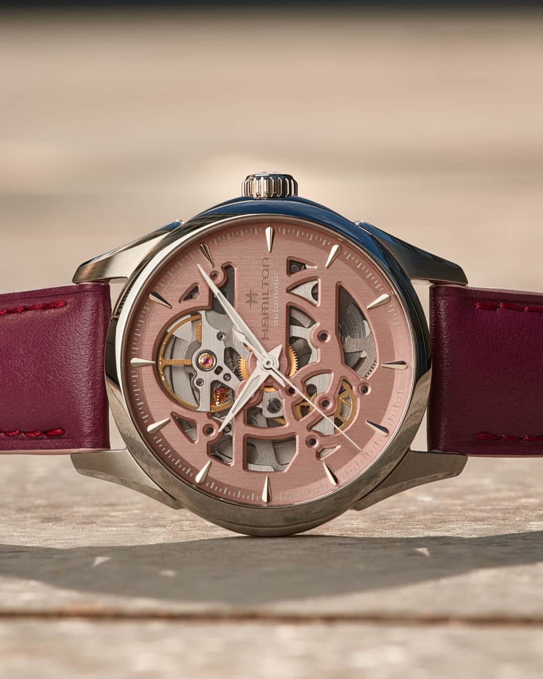 Hamilton Watchのインスタグラム：「The artistry of timekeeping.  This new Jazzmaster Skeleton Auto 36mm boasts a luscious plum leather strap and a contrasting light pink skeletonized dial, giving a fascinating glimpse into the workings of its movement.  #hamiltonwatch #new #watch #watchoftheday  (Ref. H32265870)」