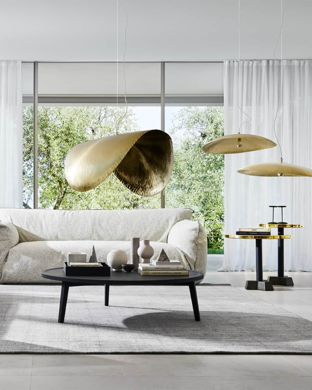 ジェルバゾーニさんのインスタグラム写真 - (ジェルバゾーニInstagram)「NUVOLA 12 sofa/ Minimal chic living room kissed by gold⁠ ⁠ The foundation of this space is a palette of soft, neutral tones, where the cocoon effect of the Nuvola sofa lies. ⁠ ⁠ The Nuvola sofa invites with its soft and attractive design, enveloping you in a cozy embrace. Complemented by the exquisite Brass collection, featuring brass lamps that gracefully float, reflecting light with poetic elegance.⁠ Delicate and sober, the golden accents of this living room are carefully designed. The Brass golden coffee tables adorn the sofa, diffusing a warm, inviting light and adding a touch of sophistication.⁠ ⁠ A design by @paola.navone⁠ ⁠Styling @ilariabacciocchi⁠ Photo @maxrommel⁠ ⁠ #gervasoni1882 #homestyling #minimalism #interiordesign #livingroomdecor #livingroomdesign #paolanavone⁠」8月15日 22時20分 - gervasoni1882