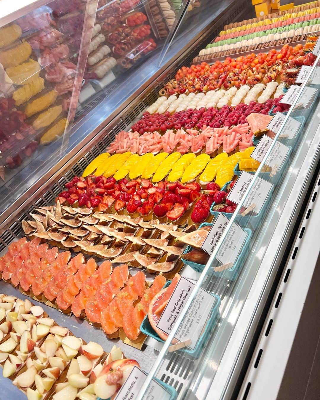 DOMINIQUE ANSEL BAKERYのインスタグラム：「Beautiful Summer Marché in full swing in Soho, 10 different fresh fruit tarts with ripe summer fruits we’ve sourced from all around the world. Here through Sunday 8/6 only. 🍒🥭🥝🍑🍋🫐🍓🥥🍊🍍」