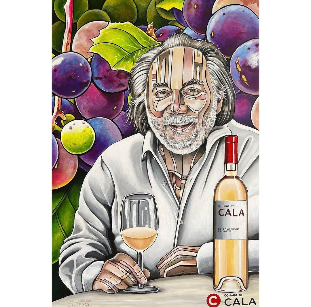 デヴィッド・ギルモアのインスタグラム：「Commissioned portrait of Joachim Splichal, Michelin-starred chef, founder of The Patina Restaurant Group in Los Angeles, and owner of Domaine de Cala winery. I depicted Joachim with patterned skin, enjoying a glass of his rosé, surrounded by over-scaled grapes. Scroll on through to see the portrait with Joachim at his winery in Provence, France. I’ve had his exceptional rosé  which I recently took to the Hollywood Bowl.  So happy you like your portrait. Merci beaucoup!  24” x 36” acrylic on wooden panel.  @domainedecala  #domainedecala #joachimsplichal #davidgilmorestudio #commission #portraitart #vinopainting #provence #provencefrance #patinagroup #frenchart」