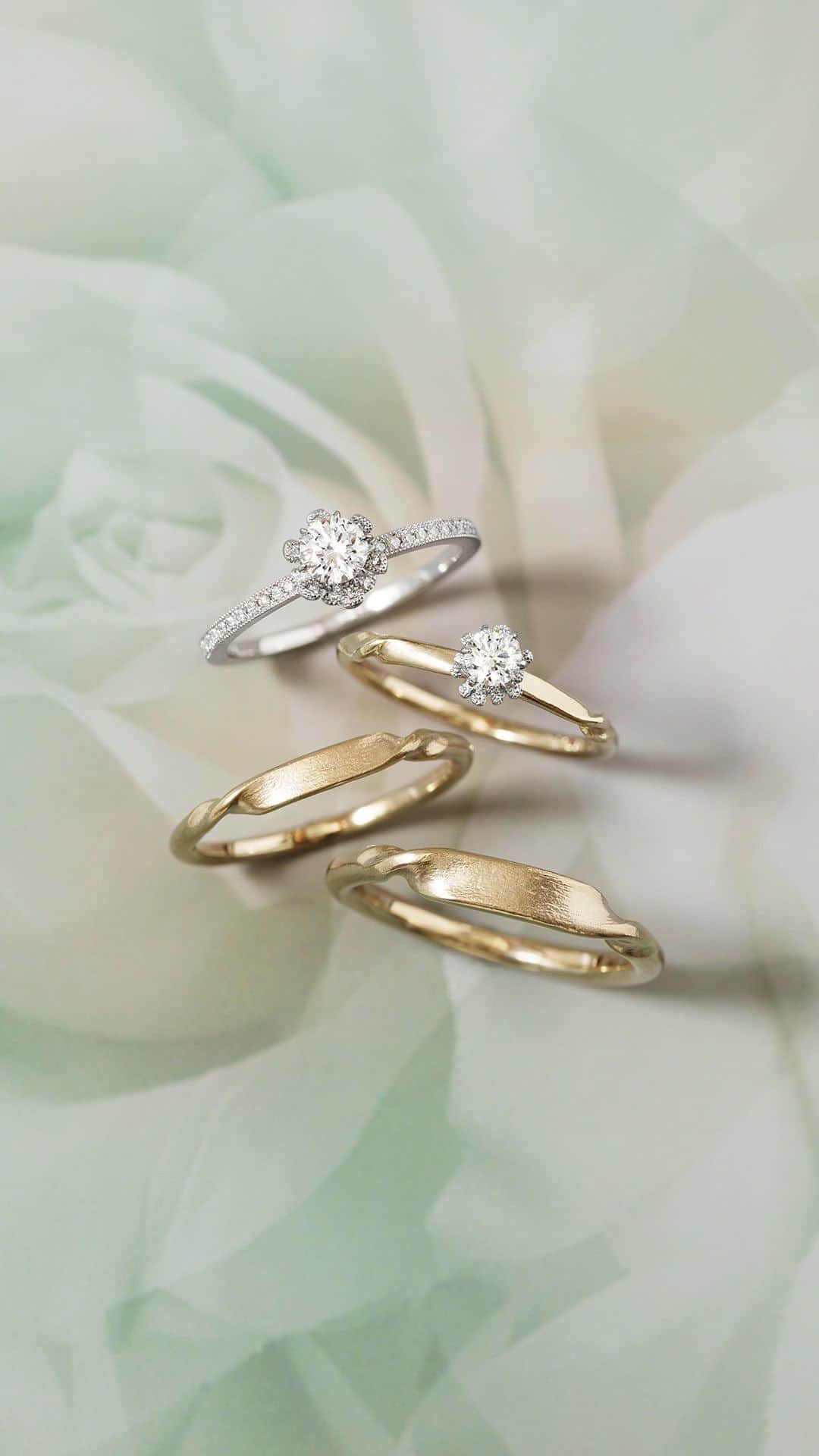 AbHerї〈アベリ〉のインスタグラム：「【 AbHerï Bridal Collection “Eternal Rose” 】古代から愛を伝えるために贈られてきた薔薇をイメージしたエンゲージリングと、ゆるやかなひねりが終わりのない輪をつくるマリッジリング。永遠に続く愛をテーマにしたブライダルコレクションです。   エンゲージリングは、華やかなエタニティタイプと柔らかなナチュラル仕上げタイプの2種類をご用意。一枚ずつ丁寧に重ねられた花びらが高さのある石座を形づくります。ふっくらとした花から幸せの甘い香りがたちのぼってくるようです。   マリッジリングは、スタイリッシュなフォルムながらあたたかみを感じさせるマットな質感。終わりのないメビウスの輪のようにふたりの物語が永遠に続くことを願ってデザインしています。オプションで、トップの平らな部分にローズカットダイヤモンドやカリグラフィ文字を入れることもできます。   クラシカルな表情の薔薇と軽やかなアームとのコントラストが魅力のコレクション“Eternal Rose(エターナルローズ)”。ぜひ店頭でお試しくださいませ。 　 　 　 ＜“Eternal Rose”＞ ■Grading Diamond Ring（中石0.3ct） Design №：857ARO3 Details：PT, Diamond ＊中石は0.2ct～お選びいただけます。   ■Diamond Ring（0.18ct） Design №：730D Details：PT, K18CH, Diamond   ■Ring Design №：730A Details：K18CH 　 ■Ring Design №：730B Details：K18CH 　 　 　 ▶ご来店はご予約がおすすめです。 @abheri_official のリンク先、オフィシャルサイトの​「Stores」よりご予約くださいませ。   ▶7/31(月)まで「ブライダルフェア」開催中。フェア詳細は @abheri_official のリンク先、オフィシャルサイトの「News」よりご覧くださいませ。   　 　 　 #abheri #abherï #アベリ #アベリブライダル #ジュエリー #ブライダルジュエリー #リング #ブライダルリング #ダイヤモンドリング #エンゲージリング #エンゲージリング探し #エンゲージリング選び #マリッジリング #マリッジリング探し #婚約指輪 #結婚指輪 #婚約指輪探し #婚約指輪選び #結婚指輪探し #結婚指輪選び #ウェディングリング #シャンパンゴールド #ゴールドリング #セットリング #プロポーズリング #ブライダルフェア #jewelry #diamondring #engagementring #weddingring」