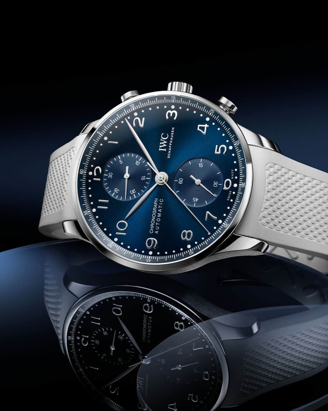 IWCのインスタグラム：「Superlative Contrasts.  A deep blue dial complemented by a textured white rubber strap.   #IWCportugieser | #TheReference  🔗Link in Bio  ℹ Blue dial Stainless steel case 41mm IWC-manufactured 69355 Calibre Ref. IW371606 - Visit your IWC boutique or retailer to discover the variety of strap options available.」