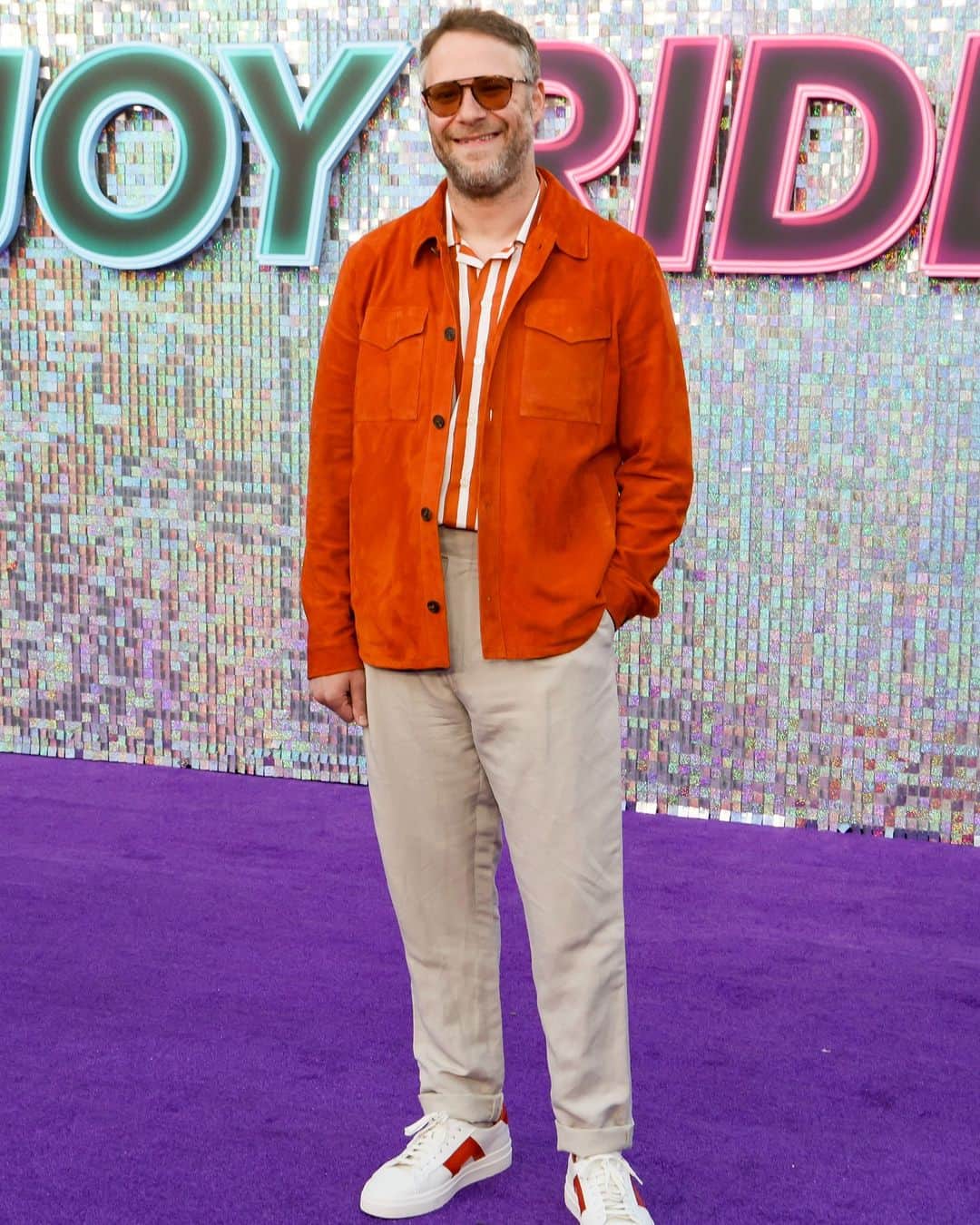 カナーリのインスタグラム：「@sethrogen at the Los Angeles premiere of "Joy Ride", wearing a #CanaliSS23 orange and white striped button up collared shirt paired with an orange suede safari jacket and taupe linen straight leg cuffed hem pants. Styled by @wendiandnicole #Canali1934」