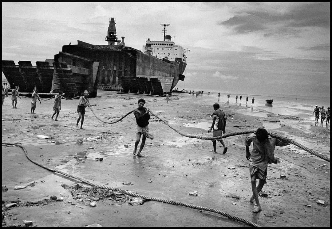 Magnum Photosさんのインスタグラム写真 - (Magnum PhotosInstagram)「@ianberrymagnum: “Old ships are rarely broken up in the west now due to their asbestos content so the job is done mainly in India and Bangladesh. ⁠ ⁠ "Ships are driven at full throttle and high tide onto the beach to ensure they are securely stuck in the sand and a gang of bare-handed, bare-footed workers tear them to bits, mostly by hand. ⁠ ⁠ "Shipyard owners are increasingly wary of any publicity so my wife drove until I could see what was going on. I had to be fairly circumspect, not wishing to be seen by either the workers or the bosses. This was one of the many trips I self-funded for the book.” ⁠ ⁠ 🔗 Following his book launch at the Magnum Gallery in London last month, Ian Berry shares the story behind five images from his new book, Water, at the link in bio.⁠ ⁠ PHOTO: Chittagong. Bangladesh. 2000.⁠ ⁠ © @ianberrymagnum / Magnum Photos」7月26日 0時01分 - magnumphotos
