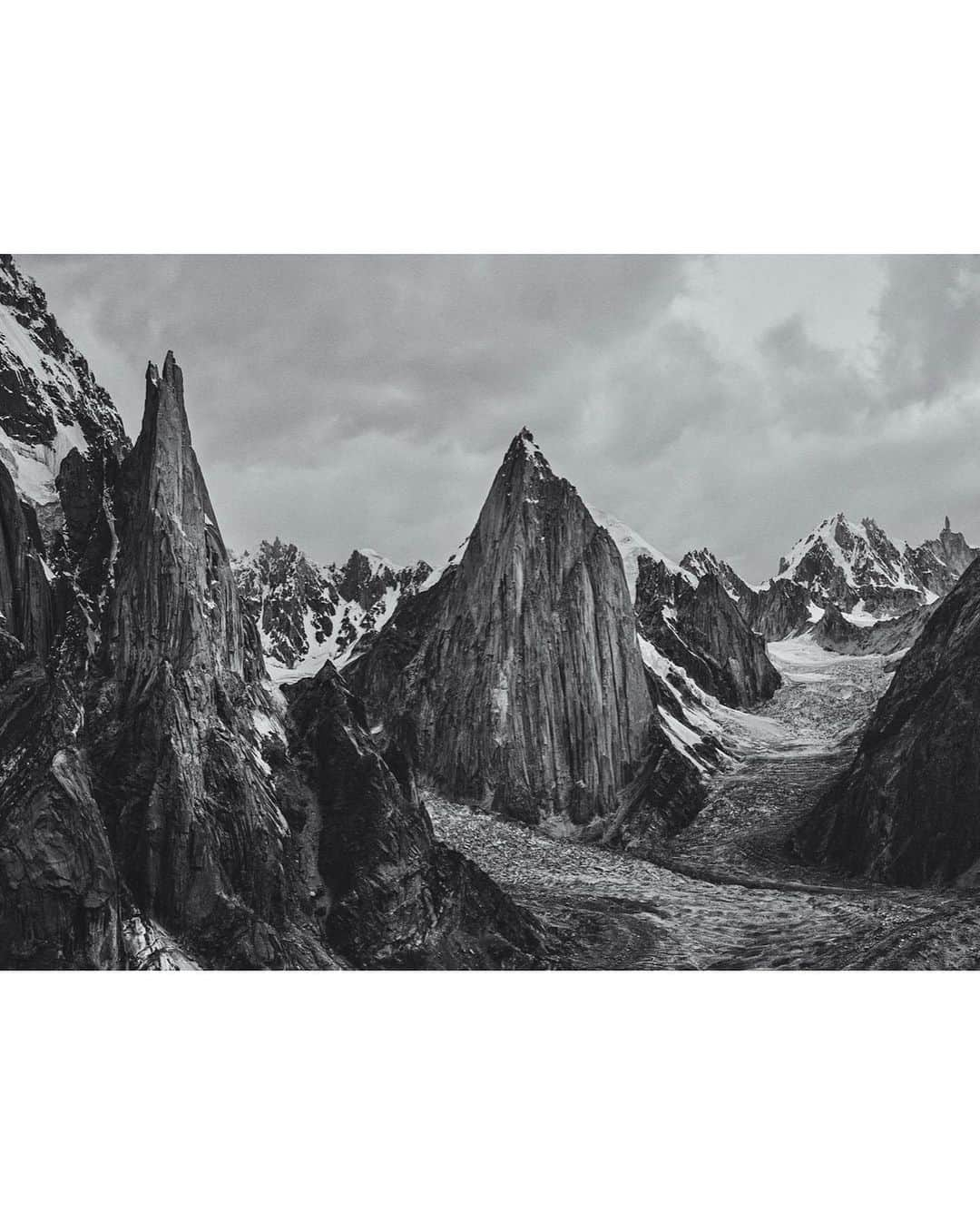 ティム・ケンプルのインスタグラム：「B+W or Color?!⁣ ⁣ It’s been amazing to see the stories and videos coming back from the past couple of seasons of rock climbing in the Trango Valley of Pakistan. This has to be one of the most remote locations for big rock climbs in the world. A full week of travel just to get to basceamp even with modern day approaches. ⁣ ⁣ The latest @reelrock is live with an amazing story about @babsizangerl and @jacopolarcher climbing Eternal Flame… and I can’t wait to watch! @edumarin1 shared his journey live from the wall all last season and continues to share clips from his epic month living on the wall. And I’ve been getting sat messages from @mattsegal @jessehuey @cannonjtc who are climbing as we speak.⁣ For now I guess I’ll have to stick to adventures in printing…😂 ⁣ ———————————————-#climbing #rockclimbing #camp4pix #pakistan #trangotowers #printing #bigprints ⁣ @canonusa  ⁣」