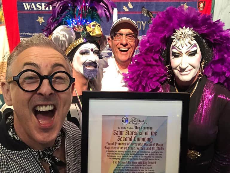 アラン・カミングのインスタグラム：「Truly the most exciting thing in ages happened to me a couple of weekends ago!  I was canonised!! Yes! You are looking at Saint Starseed of the Second Cumming! I was hosting the Fire Island Dance Festival and on the last performance I was surprised by two of the Sisters of Perpetual Indulgence (an incredible group of queer activists who amongst other things produced the first ever pamphlet about safe sex during the AIDS epidemic) and I was made Saint Starseed of the Second Cumming, Proud Protector of Foreskins, Queen of Queer Representation on stage, screen and all media. Such an honour. Thanks you so much @sfsisters,  and Tom Viola and everyone at @bcefa and @dradance for making it all happen! I will take my sainthood seriously and endeavour to continue my good works!」