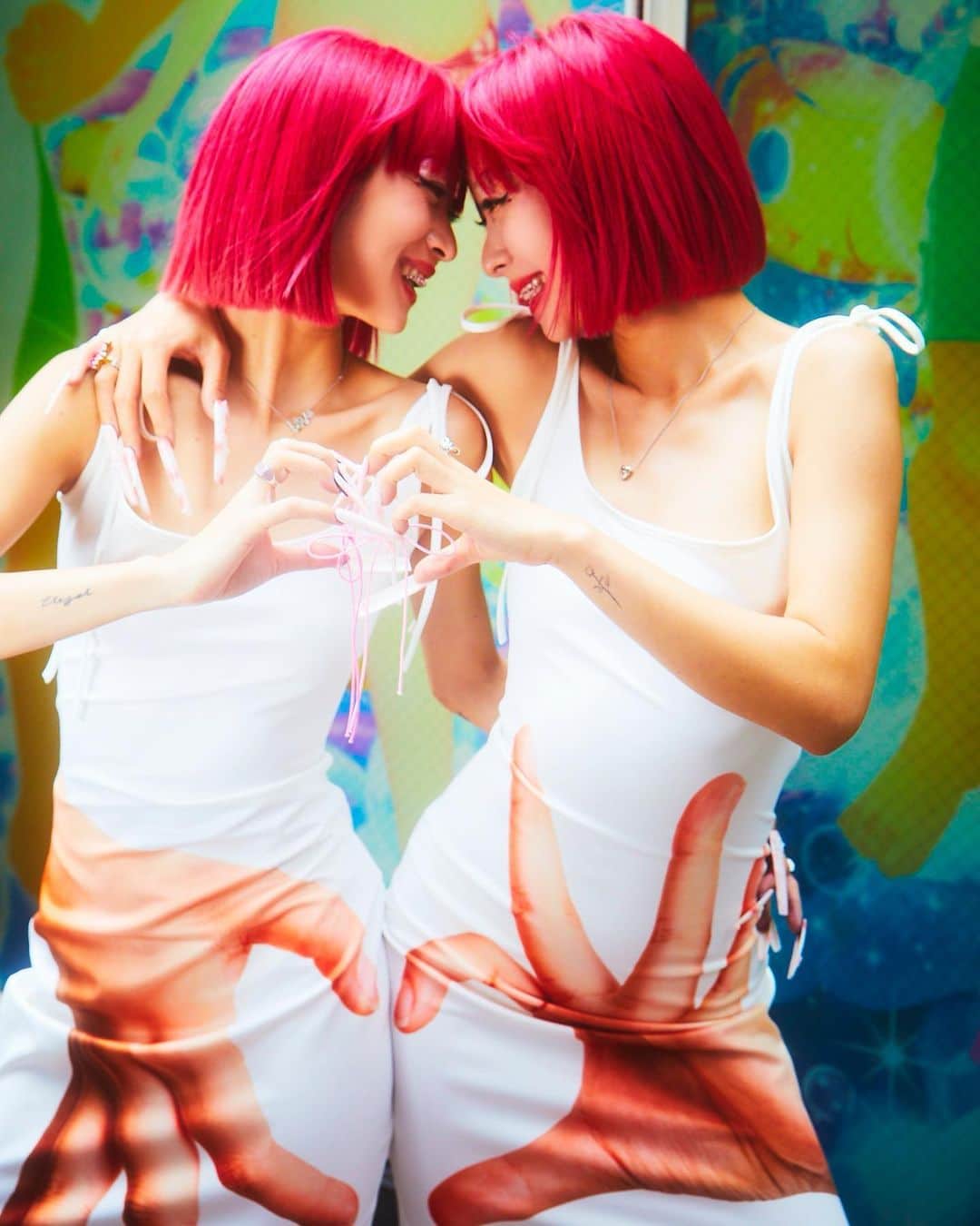 AMIのインスタグラム：「Tokyo Twinz🫶🎀  Creative Director & Stylist: @marinabhl Photographer: @shotaro_yamagoe Make up: @naoyossii Hair: @yuukiyanase Nails: @me_naillls_ Gems: @daichimrtk Production: @nacremgmt Production assistant: @hina_journey Stylist assistant: @yasminatdv  LOOK1 heart matching dresses @hu_die_gong_zhu  LOOK2 AMI TOP & SHORT: archive vintage piece unknown Shoes: @predilection.2ndshop Jewelry: @justineclenquet  AYA TOP & SKIRT: archive unknown pieces Shoes: @ysl Jewelry: @justineclenquet  #amiaya」