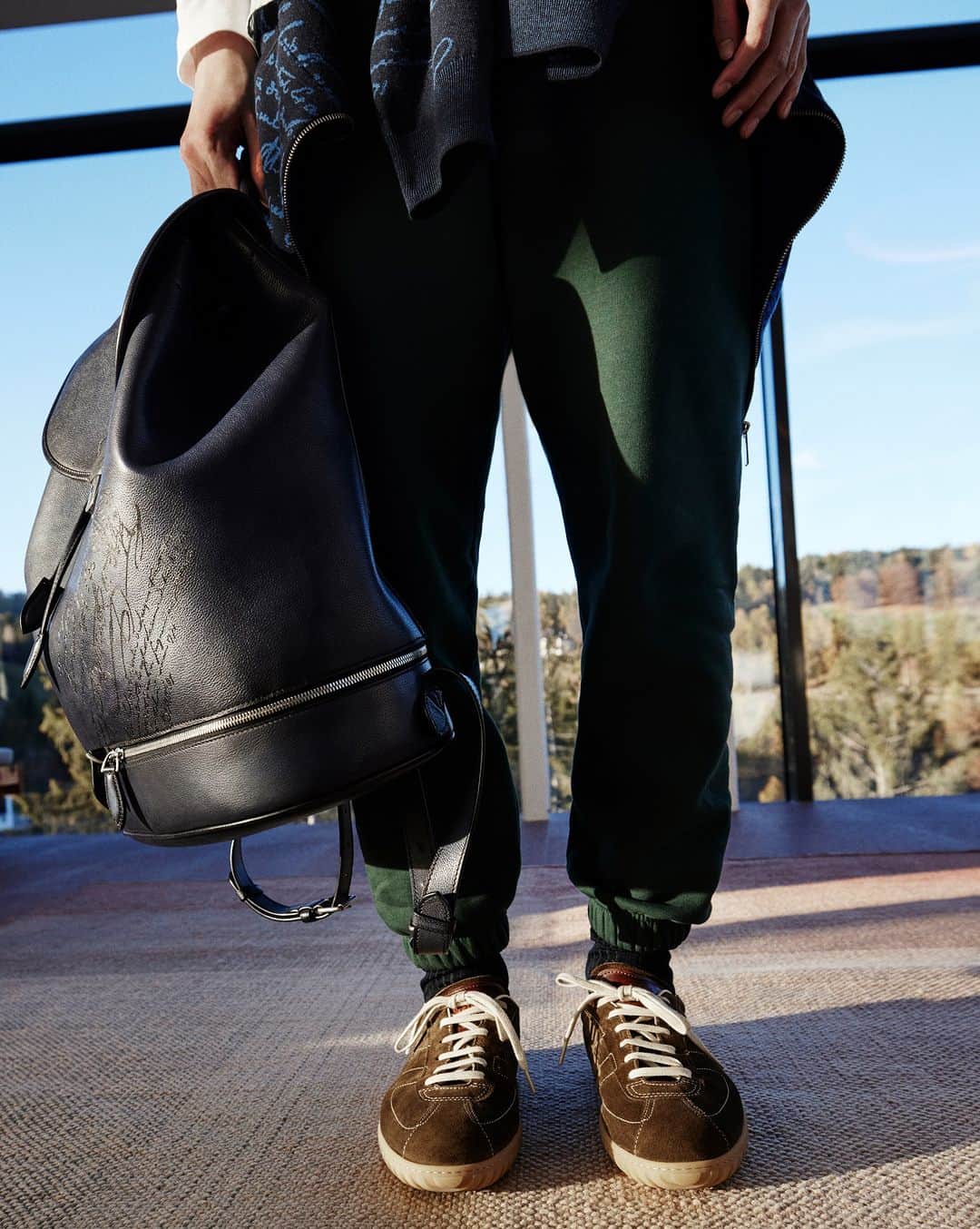 ベルルッティのインスタグラム：「- THE SILHOUETTE: FALL 2023 BY #BERLUTI -   A new backpack joins the Jour Softy line for Fall 2023. Spacious yet compact and made of  uniquely softy Venezia Gloria leather, Escape is a perfect overnight bag, complete with a shoe compartment at its base. Meanwhile, the essential New Trainer provides unique comfort, no matter what adventures may arise. Weekend away, anyone?   Now available online and in-store.   Styling by @virginiebenarroch  Photography by @anthonyseklaoui   #BerlutiFall2023」