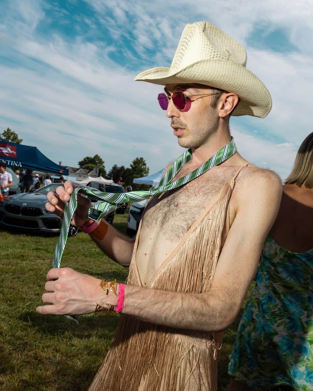 New York Times Fashionさんのインスタグラム写真 - (New York Times FashionInstagram)「At parties in the Hamptons this weekend, extravagance was a theme – especially when it came to attendees’ wardrobes.  “Go big or go home, right?” said Shani Grosz, who wore an immense straw hat to Polo Hamptons, an annual cocktail party and polo match on Saturday. The event drew a crowd of more than 900 people to the sprawling, private Fishel estate in Bridgehampton, New York. The model and actress Christie Brinkley sipped from a small bottle of rosé from Bellissima, her wine label, which people were also drinking nearby.  Later that evening, about 20 minutes away in East Hampton, young women playing flutes in long white dresses stood along a sandy path leading to a benefit at the LongHouse Reserve. (The theme was “Midsummer Dream.”) The event included a dinner, an auction and a dance party, and honored the artist Mary Heilmann and the author A.M. Homes. Attendees included Candace Bushnell, Cindy Sherman, Renee Cox, Bill T. Jones and Robert Wilson.  See more photos from the Hamptons social scene at the link in bio. Photos by @rebeccasmeyne」7月28日 0時02分 - nytstyle