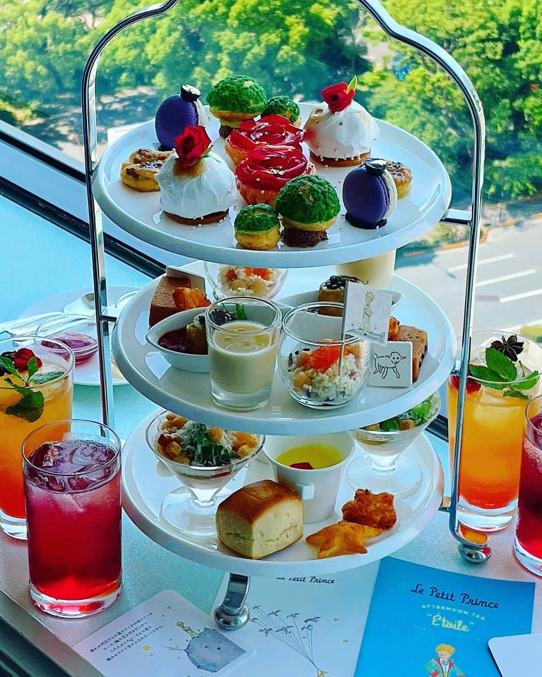 里井真由美さんのインスタグラム写真 - (里井真由美Instagram)「🇯🇵帝国ホテル東京17階から〜  人気童話『星の王子さま』とのコラボレーションアフタヌーンティー「アフタヌーンティー エトワール(Afternoon Tea Étoile) 」でございます〜⭐🩵️🤴⭐️  @imperialhotel_jp_official   世界中で親しまれている『星の王子さま』が出版80周年を迎えた事を祝し、  物語のエピソードや作者サン＝テグジュペリ氏にちなんだメニューが3段ティースタンドに華やかに登場でございます⭐️✨⭐️✨🩵🩵  なんて可愛くて なんておいしいのでしょう〜⭐️🤴⭐️🩵  今回も、 杉本 雄 総料理長をはじめ、皆さまの技とセンスが光るアフタヌーンティーでございますのよ〜✨🩵🤍🤴⭐️  @yusugimoto_official   。。。  個人的なお気に入りは、  ～王子さまの星～ ムースフロマージュ♡ ふわっふわで　中から南国果実のコンポートがとろ〜り💛 りんごで仕上げた薔薇🍎🌹ラ・ヴィ・アン・ローズも丁寧さが光るお品。 セイボリーでは、紅ズワイ蟹とホタテのタブレ 、タラのブランダードも好み🩵  お皿や薔薇の周りにもキラキラ金箔の星、 アラザンのシルバーが散らされていて、 星の王子様の世界観が広がっています✨  ファーストドリンクもおいしいですし、 オプションでのノンアルコールカクテル 「Eternal Love in our Life」もおすすめ🌹  ワインビネガーに、スパイスや柑橘類を漬け込んだシュラブとオレンジジュースがミックスされたモクテルです🌹  。。。  星の王子さま　で　印象的な言葉は 「大切なものは目に見えないんだよ」  愛や生命の大切さを さりげなく優しく伝えてくれる本 🩵🤴⭐️✨✨  これからも 愛と感謝を軸に生きるぞ🤍  なんて思いながら完食♡ あーおいしぃ😆🩵  。。。  星の王子さまアフタヌーンティー 7月1日（土）～8月31日（木） 価格：2,450円（サービス料・消費税込） 時間：11:30～20:30（ラストオーダー）  お電話ご予約🔻 03-3504-1111  @imperialhotel_jp_official   。。。  メニュー書いておきますね〜  1段目：デザート】 ・～王子さまの星～ ムースフロマージュ ・～バオバブの木～ シュー・ア・ラ・クレーム ・～小惑星～ ブルーベリーのマカロン ・イチジクのクラフティ ・～星に咲く一輪のバラ～ ラ・ヴィ・アン・ローズ 【2段目：セイボリー】 ・～ヒツジの箱～ 羊のチーズとイチジクのタルト ・チキンのソテー プロヴァンス風 ・紅ズワイ蟹とホタテのタブレ ライム風味 【3段目：セイボリー】 ・タラのブランダード　サフラン風味のコキヤージュソース ・クープグラスに仕上げたリヨン風サラダ ・ヨーグルトスムージー ・プレーンスコーン  。。。  #帝国ホテル東京 #帝国ホテル#impelialhotel #星の王子さまアフタヌーンティー #星の王子さま#アフタヌーンティー#PR #アフタヌーンティー#afternoontea #ヌン活 #アフタヌーンティー好き#アフヌン  #里井真由美#フードジャーナリスト里井真由美#さといいね#ありが糖運動#japan#japanesegirl#japanese」7月28日 0時37分 - mayumi.satoi