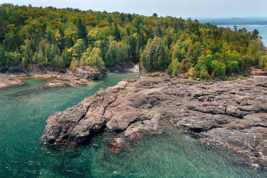 National Geographic Travelさんのインスタグラム写真 - (National Geographic TravelInstagram)「Photos by Michael George @michaelgeorge | I never knew the Midwest had a wild side. After years of hearing mythic references to Michigan's Upper Peninsula, I had the chance to see it for myself. In Marquette, an energetic hub on the shores of Lake Superior, I strolled the main street and visited with local artists like Stella Larkin. Only a few minutes from downtown is Black Rocks, a dramatic formation of Jacobsville sandstone where waves crashed below me. I love a town where you can be in nature before you know it. Driving north to Copper Harbor I discovered a seemingly endless network of mountain biking trails. The Upper Peninsula offers wonders both day and night. While visiting one of the country's newest dark-sky parks, I saw the northern lights for the first time. My final adventure took me to one of the least visited national parks—the mysterious Isle Royale. Flying in by seaplane, I was greeted by an archipelago packed with outdoor activities, and I even spotted a mama moose with her baby. A fitting finale to my week of exploration. | Whether you're an urban adventurer, outdoor enthusiast, or traveling with family and friends, Michigan has something for every traveler. @PureMichigan #KeepSummerFresh.」7月28日 22時40分 - natgeotravel