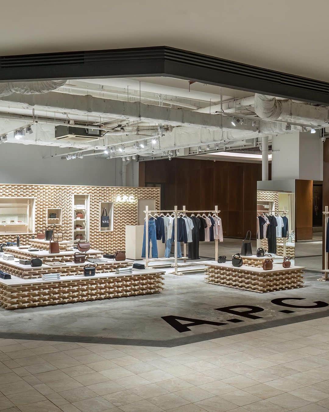 アーペーセーのインスタグラム：「A.P.C. MANILA IS OPEN.   Located in Makati City’s historic Power Plant Mall, the store features a deliberately open and raw space, designed as a wood and concrete showcase, with a unique wall install made of stacked light wood logs.   Drop by to discover the space and shop our timeless pieces and new PF23 accessory and ready-to-wear arrivals.  A.P.C. MANILA Stall No. R1-157C R1 Level, Power Plant Mall, Rockwell Center, Makati City  #APCParis #APCStore」