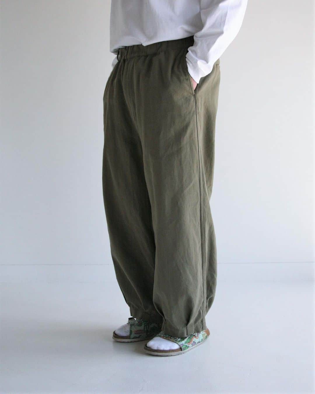 アナクロノームさんのインスタグラム写真 - (アナクロノームInstagram)「. AN236 HEM TUCK EASY PANTS OLIVE  [アイテム : 裾タックイージーパンツ]  裾にタックを取ることで適度なふくらみのある独特なシルエットを表現したイージーパンツ。 フロント部分のループには、キーやウォレットを付けることが可能です。  ■生地 : ナチュラルストレッチツイル 揉み込み柔軟加工による風合いとナチュラルストレッチ性が特徴の素材です。  ■加工 : 反応染 製品染めでしか出せない絶妙で柔らかなカラーリングとなっております。  ※製品染のため、寸法に多少誤差がでることがあります。 ミルスペックのように染色アイテムにつけているタイベック素材は熱に弱いため、アイロンのご使用はお控えください。  ■素材 : COTTON 100%  ウエストはゴム仕様となっており、広げると約14cm広がります。  海外発送も可能です。 Overseas dispatch is also possible.   MODEL 身長：181cm 体重：88kg 着用：SIZE 03」7月31日 10時50分 - anachronorm262