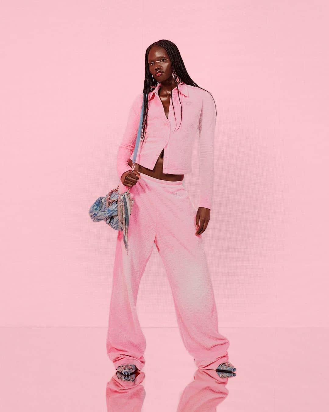 ディーゼルのインスタグラム：「Soft, pink places.    An elevated alternative to sweats, a matching pastel pink button down top and track pants display the new all-over monogram applied to soft chenille jacquard.    Tap to shop and discover more at the link in bio.   #ForSuccessfulLiving #DieselFW23」