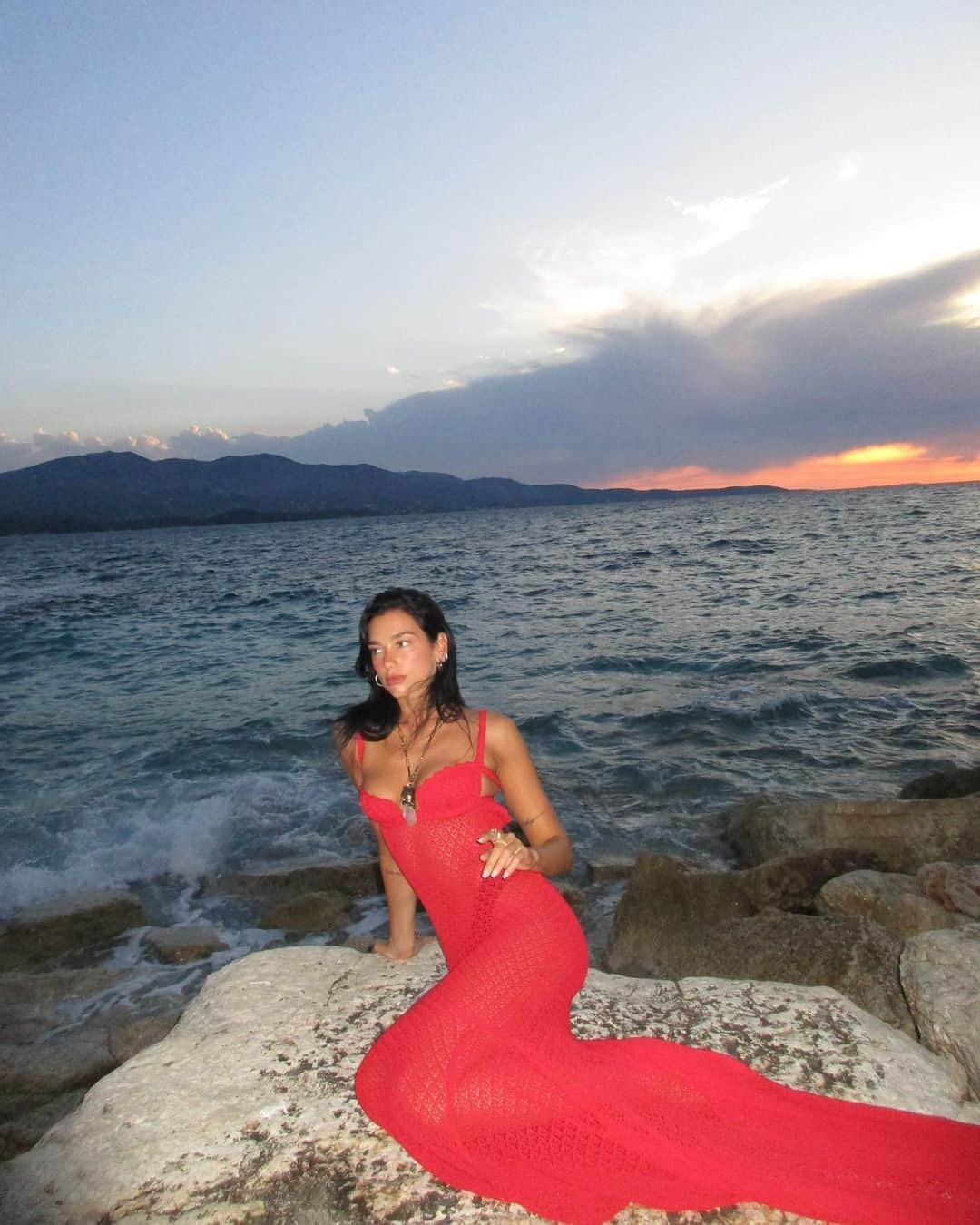 Harper's BAZAARのインスタグラム：「#DuaLipa has put her own fiery spin on the mermaid aesthetic. The singer shared snaps from her recent getaway to Albania, highlighting a sultry @blumarine crochet gown. Underneath, she wore nothing but a visible black thong. Tap the link in bio for more of her trip.」