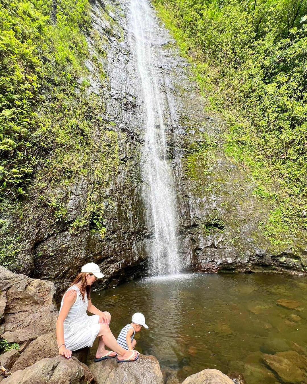 藤田志穂のインスタグラム：「アヒポケを腹ごしらえしてからは、マノアの滝を見る為に山登り⛰️ ・ 最初は子鉄が登りきれるか心配だったけど🫤 ・ 傾斜は緩やかなので、5歳の子鉄も「あと何分〜？」なんて言いながらも自分の足で登りきれました👏 ・ 山登りと言っても、私も子鉄もサンダル🩴😂 ・ スニーカーとかの方が登りやすいのかもしれないけど、下がぬかるんでいるので、足裏の泥の跳ね返りやら気を抜くとぬかるみにはまり汚れるので、サンダルだと水で洗い流せて楽ちんだったかも🤔 ・ 今までは、ハワイと言えば海！ばかりだったので、子鉄と初めてのハワイの楽しみを味わえたのも良い思い出☺️ ・ とは言え マブダチの @kikichiaki の息子くんや、 @mmari0325 の息子くん&友達のお兄ちゃん達が居たのも良かったのかもな😊 ・ また次に来た時には、もっと色々なアクティビティが出来るようになってるんだろうなー💙 ・ #マノアの滝 #manoafalls  #子連れハワイ #蚊が多め #虫除けを持ってると思いきや #何故か #私のバッグには #キャップしかなかった #なんでやねん😂 #そして #常にバッグのチャック全開🤫」