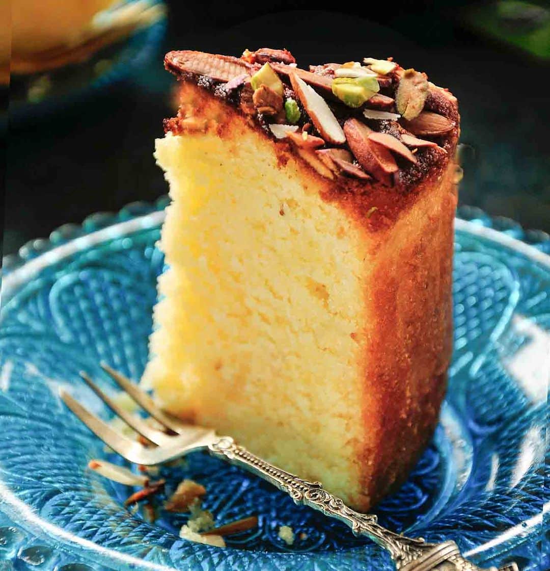 Archana's Kitchenのインスタグラム：「#ParsiNewYear   Celebrate Parsi New Year with this most delicious Mawa cake recipe. Tastes best with some masala chai.  Ingredients 1-1/4 cups All Purpose Flour 1/2 teaspoon Baking powder 1/4 teaspoon Cardamom Powder  1 pinch Salt 100 grams Khoya (Mawa) 6 tablespoons Butter (Unsalted), at room temperature 1 cup Sugar 2 Whole Eggs, at room temperature 6 tablespoons Milk Slivered Almonds, to taste Pistachios, chopped, to taste  👉To begin making the Parsi mama cake, first and foremost, set the oven to preheat at 180 degrees C. Then, grease and adequately dust a 7" pan and set it aside for later use. 👉Next, sieve together the all purpose flour, baking powder, salt, cardamom powder into a bowl and set aside. 👉In another mixing bowl, using a electric hand blender, whisk together crumbled mawa, butter and sugar for 4 to 5 minutes till the mixture is creamy, pale, light and fluffy. 👉To this mixture, add one egg at a time and whisk till well combined and smooth. 👉The next step is to add 1/3rd of the flour mixture and 1/3rd of the milk, alternatively and mix well between additions. 👉Repeat with remaining flour and milk until you get a smooth, pourable mixture. 👉Pour the batter into the prepared pan and even out the top. Sprinkle the almond and pistachio flakes around the surface. You can also sprinkle some additional cardamom powder for added flavour. 👉Place the tin in the preheated oven to bake for an hour or till a skewer inserted in the center of the cake comes out clean. 👉Remove the cake from the oven, allow it to cool and serve it at a tea party along with crunchy Pan Fried Onion Pakoras, Non-Fried Corn & Cheese Bites and Masala Chai.」