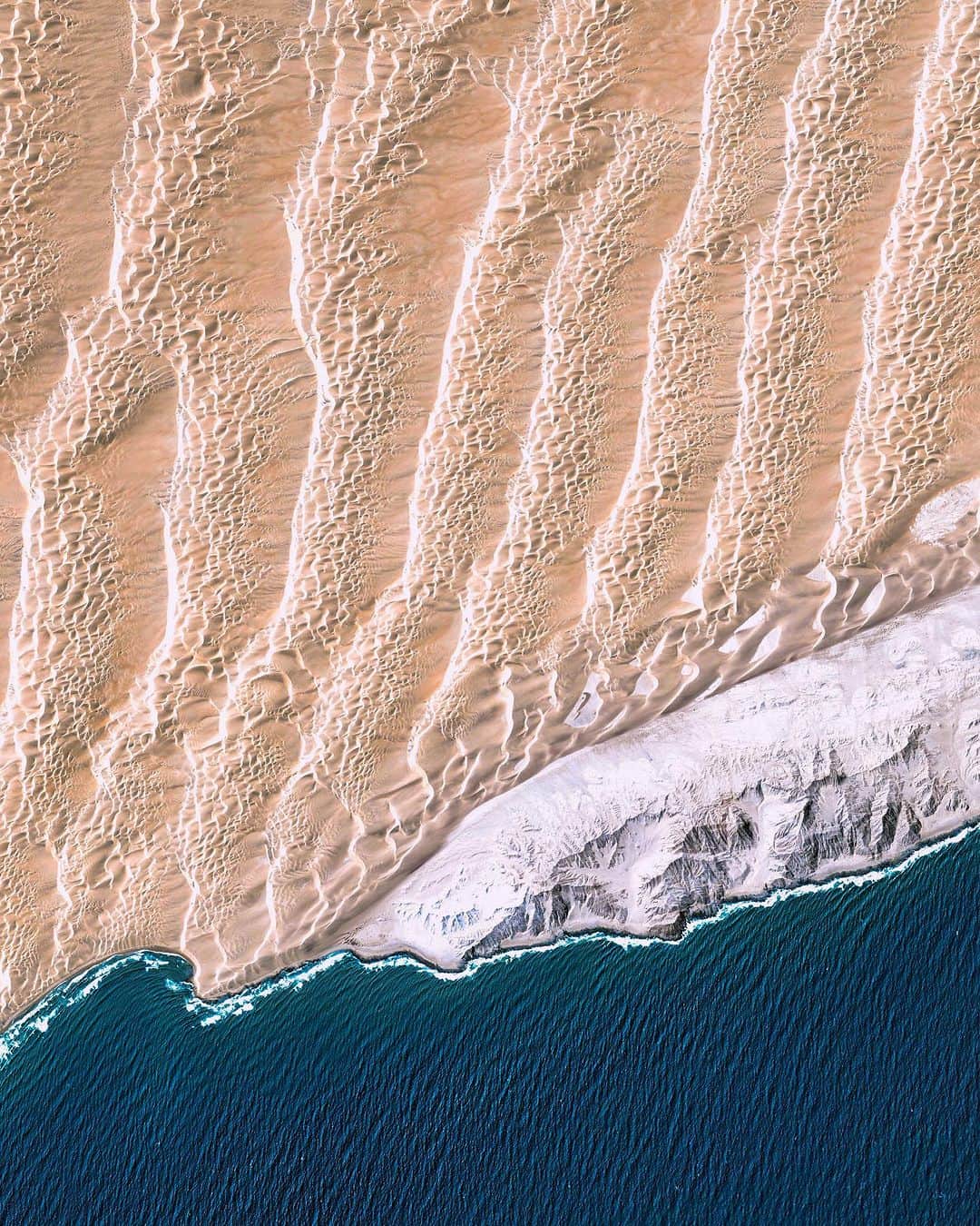 Daily Overviewさんのインスタグラム写真 - (Daily OverviewInstagram)「Rows of sand dunes meet the Atlantic Ocean in the Namib Desert of western Namibia. Dating back at least 55 million years, the Namib is thought to be the world’s oldest desert, and it contains the tallest dunes on Earth. This Overview focuses on Saddle Hill, the site of a former diamond mining operation engulfed by shifting dunes.  Created by @dailyoverview Source imagery: @maxartechnologies」8月2日 0時33分 - dailyoverview