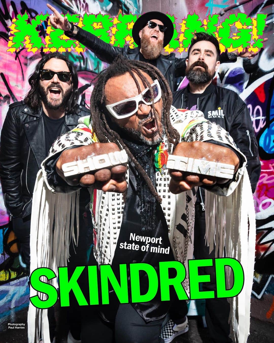 Kerrang!のインスタグラム：「Kerrang! Cover Story 💚  “We’re not hailed like a lot of bands, but it’s supposed to be like this. We’re the alternative”  Despite a stellar discography and consistently brilliant live show, Skindred have often been taken for granted by rock fans in their 25 years as a band. But no more. On the eve of the release of their fantastic eighth album Smile, the Newport heroes cast their minds back over their journey so far – and reveal why they’re hungrier than ever for the future…   Read the interview now at the link in bio 🔗   ✍️: @hickiepics  📸: @paulharries 🎨: @aledsavedlatin   #kerrangcoverstory」