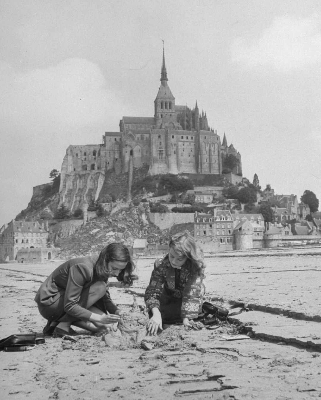 lifeのインスタグラム：「Travelers at Mont-Saint Michel building a sand replica of France's medieval abbey, 1948.   See more dreamy destinations from the LIFE archive by clicking the link in bio.   (📷 Yale Joel/LIFE Picture Collection)   #LIFEMagazine #LIFEArchive #YaleJoel #1940s #Travel #Destinations #MontSaintMichel #France #Europe」