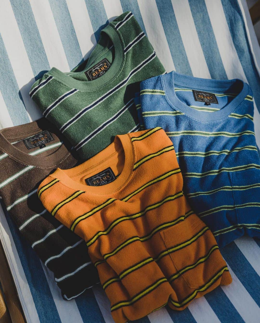 BEAMS+さんのインスタグラム写真 - (BEAMS+Instagram)「... Hope you love the laid-back vibe of BEAMS PLUS classic beachwear! ---------- ●Pocket Tee Pile Stripe A comfy T-shirt with a cool striped design, perfect for the beach. It's made from a mix of cotton and polyester for a soft feel.  ●Pocket Tee Jacquard Stripe This tee draws inspiration from vintage styles and features a unique jacquard stripe pattern created with special yarn.  ●B.D. Double Gauze Enjoy the breezy and soft feel of this gauze material, which has a lovely textured finish.  ●MIL 1 Pleat Athletic Shorts These shorts are designed with a touch of vintage charm, made from smooth nylon taffeta, and inspired by U.S. Navy swim shorts.  快適な着心地と洗練されたスタイル、BEAMS PLUSのクラシックなビーチウェア。 ---------- ● Pocket Tee Pile Stripe 海が似合うパイル素材とストライプ。コットンとポリエステルの混紡生地を使用。パイル地のループ長を短く設定し、パイル特有の重みを軽減。肌触りと着心地を考えたパイルTシャツ。  ● Pocket Tee Jacquard Stripe ビンテージ Tシャツから着想し、オリジナルで編み立てたジャカードストライプ。40番双糸を使い、4色の先染め糸で編みあげています。  ● B.D. Double Gauze 柔らかで通気性に富むガーゼ素材。生地染めを行うことでふっくらとした風合いに仕上げています。   ● MIL 1 Pleat Athletic Shorts 50デニールナイロンタフタを使用。ヴィンテージ感のある微光沢のナイロンは、もちろんオリジナルファブリック。 U.S.NAVYのスイムショーツをベースにデザインしたモデルです。 . @beams_plus @beams_plus_harajuku @beams_plus_yurakucho #beamsplus」8月8日 20時02分 - beams_plus_harajuku