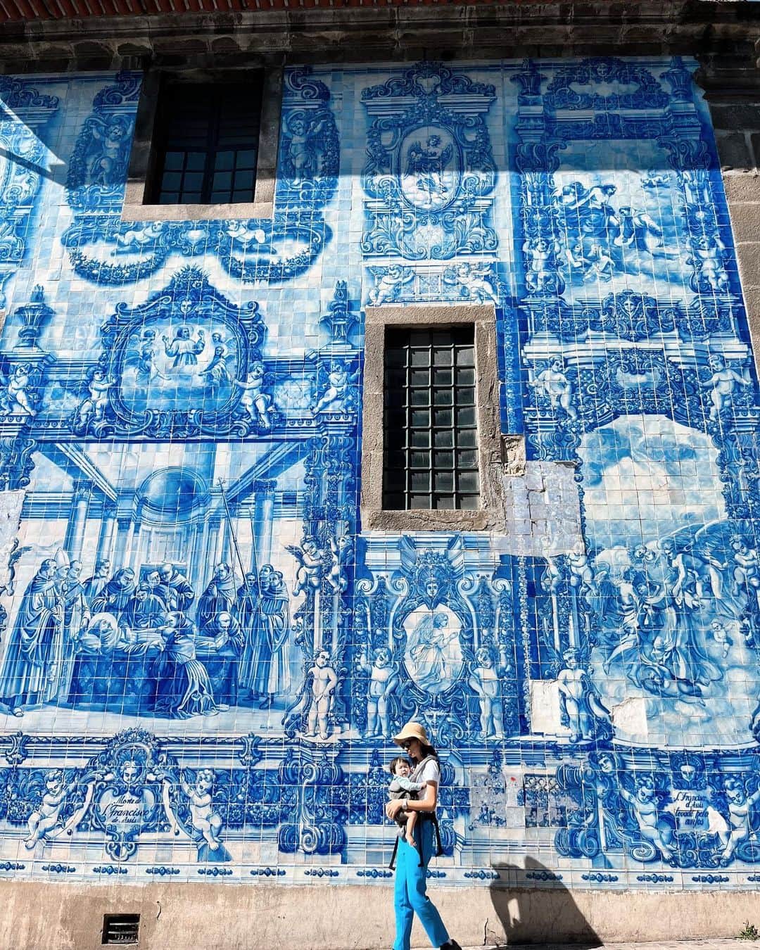 矢原里夏のインスタグラム：「📍🇵🇹Porto,Portugal 【azulejo】 あーこれ載せなくちゃ！っていう映え写真。 青の壁画「アズレージョ」はイベリア半島で生まれた、伝統的なタイルのこと。壁一面に描かれた姿は圧巻！！ヨーロッパは街の至る所がかわいいから上がるよね😍 . . . . #rikayahara #ヤハラリカ　 #ヤハラリカの地球さんぽ   #ポルトガル旅行 #Portugal #happy #子連れ海外 #trip #travel #旅行コーデ #旅コーデ #子連れポルトガル #ママコーデ #1歳ママ #子連れ旅行 #子連れヨーロッパ #ポルトガル旅行 #1歳ママ#女の子ママ #赤ちゃんとおでかけ」