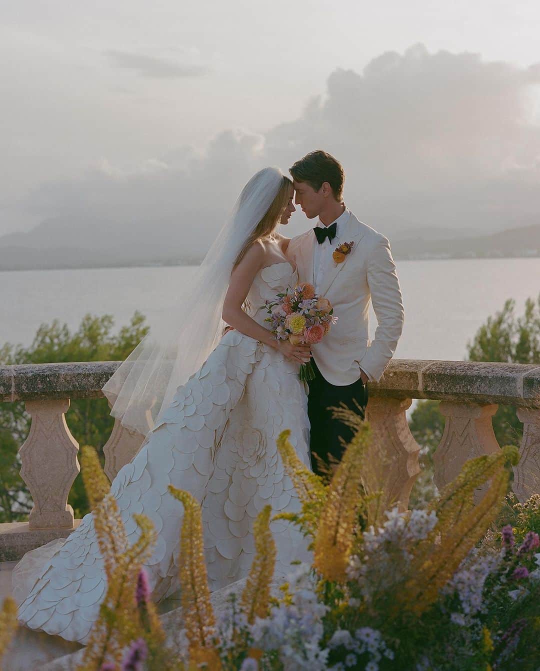 のインスタグラム：「Eternal Love 🤍 @joeyking is a vision of perfection in the #odlrbridal hand-embroidered petal ball gown with a custom drop waist for her Mallorca wedding.  Photographed by @normanandblake Styled by @jaredengstudios」