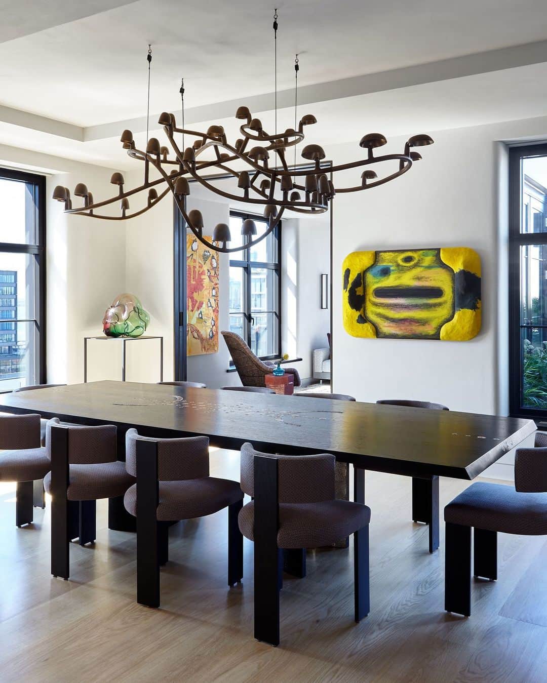 ELLE DECORのインスタグラム：「This vibrant New York City penthouse is artful in more ways than one, with the clients’ art collection playing a major role in the interiors. The dining room area, for example, pairs a serpentine chandelier by Frederik Molenschot with a neon yellow painting by Tishan Hsu. “I think when a client has taste, it comes out in both clothing, decorating, and art,” says interior designer Heather Wells (@heatherwellsinc_ ). “They have a connection. So it was nice to be able to play with that a little bit.”   Click the link in our bio to tour the rest of this city penthouse. Written by @helmadden. Photographed by @joshuamchughphotography.」