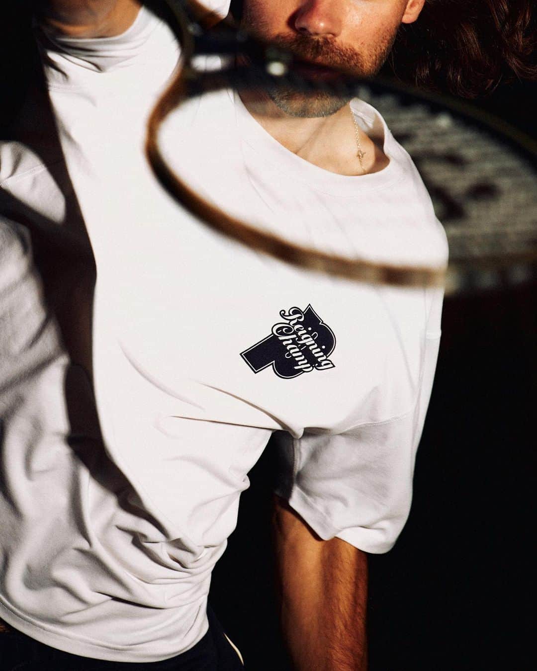 のインスタグラム：「Our @princesports vs @reigningchamp limited-edition capsule is available now.  The campaign showcases our unbridled love for the game, pivoting to the practice court where skills are honed, and work ethic takes root. We arrive at the cage for an afterhours hit, armed with a blue collar, by-any-means mentality and a whirring ball machine to play the part of our relentless adversary.  Featured styles include collaborative graphic tees, a match-ready pleated short, and the second coming of our limited-edition Prince Original Graphite 107 racquet, designed in a new colourway to complete the capsule.   #princevsreigningchamp」