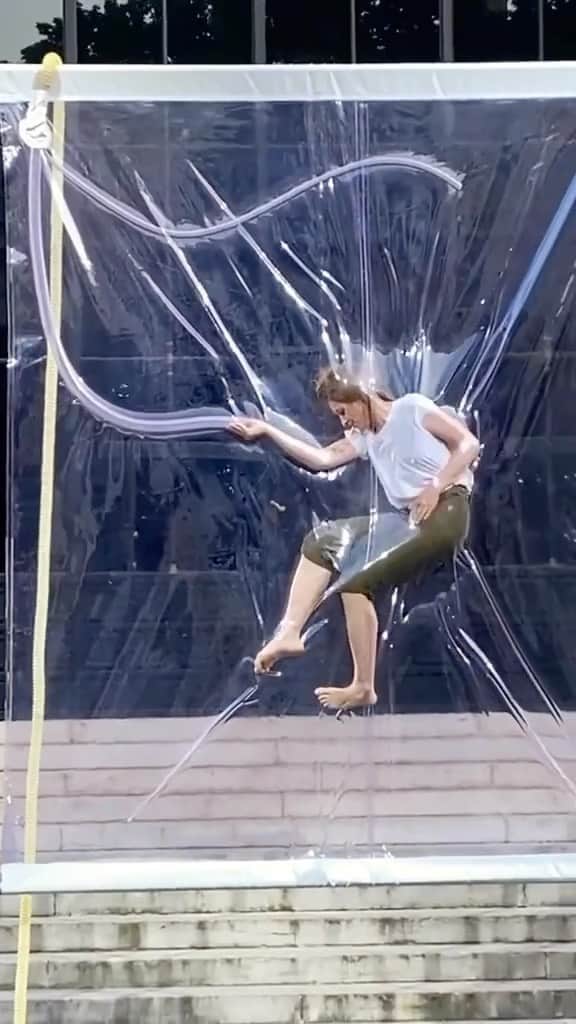 StreetArtGlobeのインスタグラム：「SHRINK by @lawrencemalstaf is an installation consisting of two sizable transparent plastic sheets and a device that gradually removes the air from the space between them. This results in the body being vacuum-sealed and suspended. The person inside the installation can control the airflow through a transparent tube that runs between the two surfaces. 😳  What do you think of this artwork? 🤷🏽‍♂️」