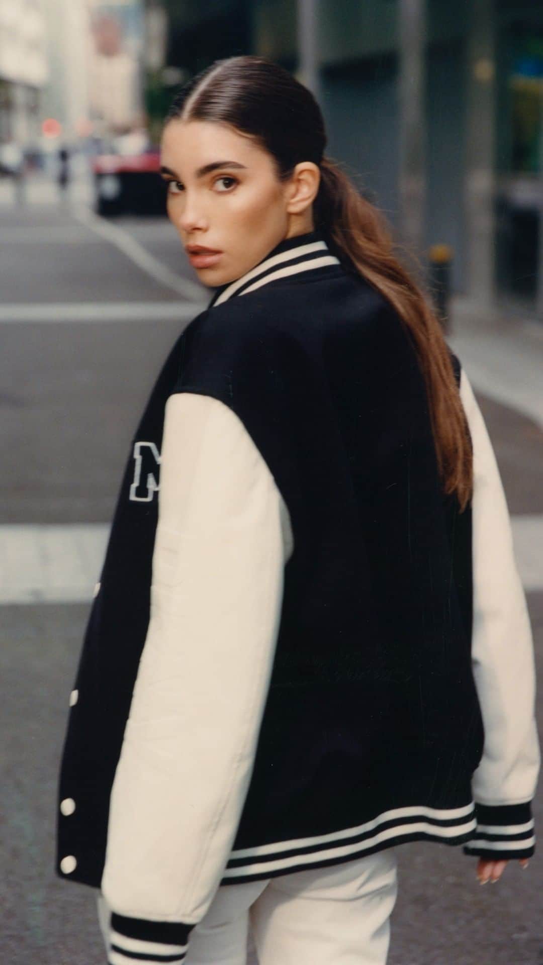 DKNYのインスタグラム：「The official city uniform.  @cindymello stars in her custom DKNY Varsity Jacket.  #DKNYFORYOU」