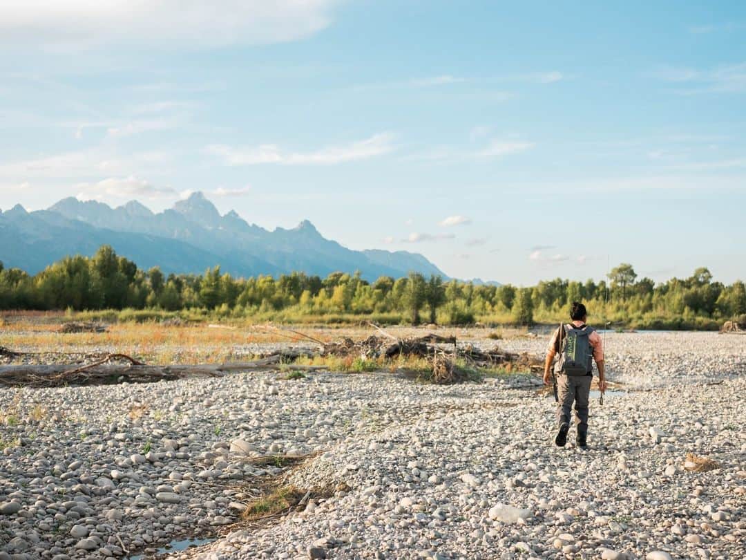 National Geographic Travelさんのインスタグラム写真 - (National Geographic TravelInstagram)「Photo by @sofia_jaramillo5 | Filmmaker and conservationist Jr Rodriguez hikes to a river in the Tetons in Wyoming while working on the movie Wading For Change, about fly-fishing. In Texas where he grew up, Rodriguez learned to fish without fancy gear or vast landscapes as the backdrop. Family and community were always present in his outdoor experiences. His love for the outdoors was solidified alongside his Latinx community and during family outings. Wading for Change shows how passion for the outdoors can blossom through community, regardless of economic status, location, or skin color. The film was recently selected by the National Geographic Short Film Showcase and premiered on  National Geographic's YouTube page on August 16. Follow @sofia_jaramillo5 for more conservation images from around the world.」8月23日 1時30分 - natgeotravel