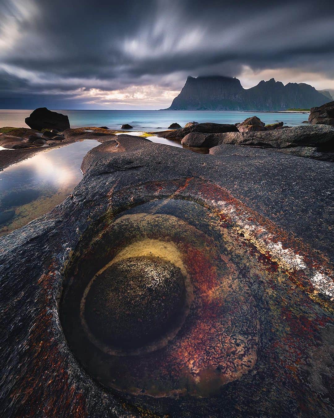 BEAUTIFUL DESTINATIONSさんのインスタグラム写真 - (BEAUTIFUL DESTINATIONSInstagram)「@karolnienartowicz presents the Dragon's Eye in Norway! 👁️ Carved by nature, this stunning rock bowl filled with water, sand, and algae cradles a round boulder, creating the mythical Dragon's Eye. 🐉 The allure is undeniable – it's as if a dragon's gaze is embedded in the landscape! 📸  Would you like to visit Norway to photograph this? 🇳🇴  📽 @karolnienartowicz 📍 Dragon's Eye, Uttakleiv Beach, Lofoten Islands, Norway」8月24日 0時01分 - beautifuldestinations