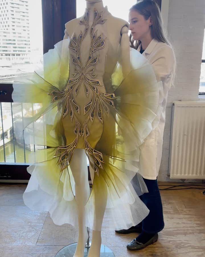 Iris Van Herpeのインスタグラム：「Inside the atelier ~ finishing touches to the 'Moon Moth’ dress. This look is made from glass organza which is intricately pleated into 5 millimieter pleats that are gradient-dyed from white to marigold, and handstitched onto blossoming networks that are embroidered onto the bodice.  #irisvanherpen #hautecouture」