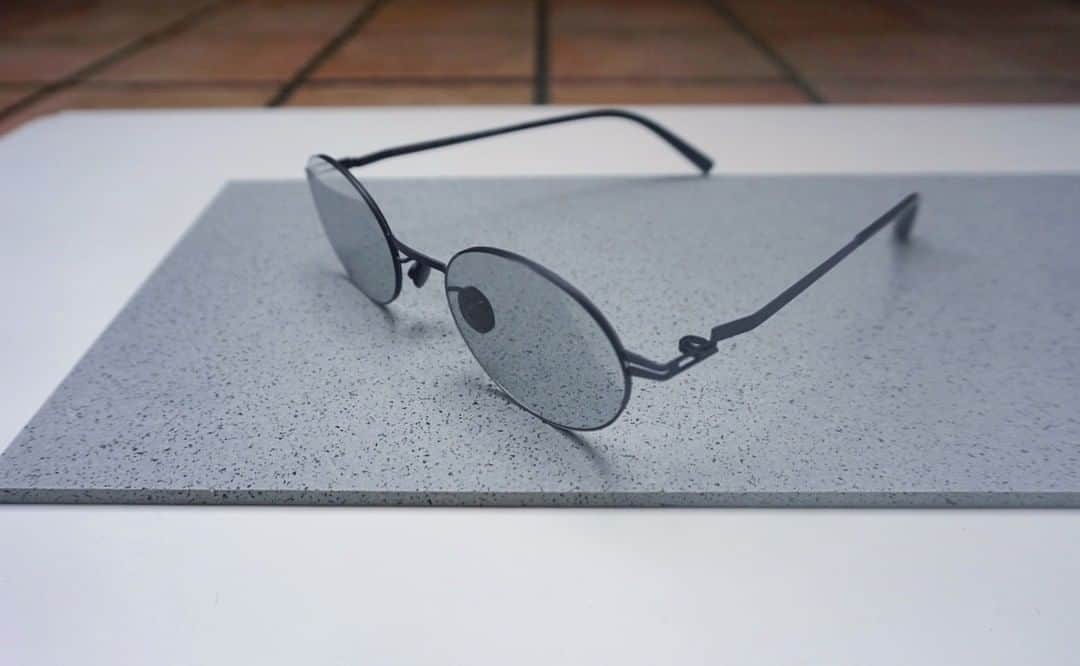 MYKITA SHOP TOKYOのインスタグラム：「【LESSRIM Collection "NAOKO Nealyblack"】   極限までリムを細くし、まるで縁がないように仕上げたLESSRIM Collectionより、Customized Model"NAOKO"をご紹介いたします。 トレンド感のあるレンズシェイプにオリジナルカラーの濃度の薄いレンズを合わせ、普段使いしていただきやすいサングラスです。 モデルカラーは一見ブラックに見えますが、実際に見ていただくと炭のようなカラーになっており、固くなりすぎないのもポイントです。 是非店頭にてご覧いただきたいモデルです。   LESSRIM Collection "NAOKO Nealyblack”   From the LESSRIM Collection, we introduce the "NAOKO", a customized model with extremely thin rims and a rimless finish. The trendy lens shape is combined with the original color of thin density lenses, making these sunglasses easy to use in everyday life. The model color looks black at first glance, but when you actually look at it, you will see a charcoal-like color, which is a key point that it does not become too hard. This is a model that we hope you will take a look at in our stores.  #mykita  #mykitalessrim  #sunglasses  #sunglassesfashion  #マイキータ  #サングラス」