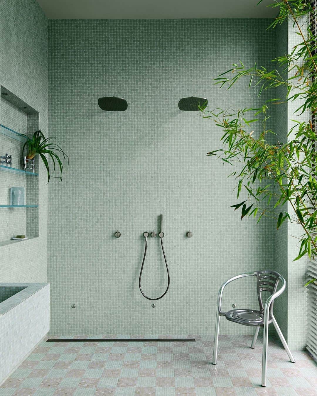 ELLE DECORのインスタグラム：「Interior design inspo can be found anywhere—especially if you’re ELLE DECOR A-List designer Mark Grattan (@markgrattan). When designing the en suite bathroom in Megan Rapinoe (@mrapinoe) and Sue Bird’s (@sbird10) New York apartment, Grattan took inspiration from his recent travels in São Paulo. The peaceful dual-showerhead sanctuary was swathed in aqua-tinted @sicis_official mosaic tiles with floor-to-ceiling aluminum shades dressing the windows. Talk about minty fresh!  Click the link in our bio for the full cover story, as seen in our September 2023 Style Issue. Written by Katherine Bernard (@meta__porter). Photographed by @sans.murs. Styled by @tessawatson.」
