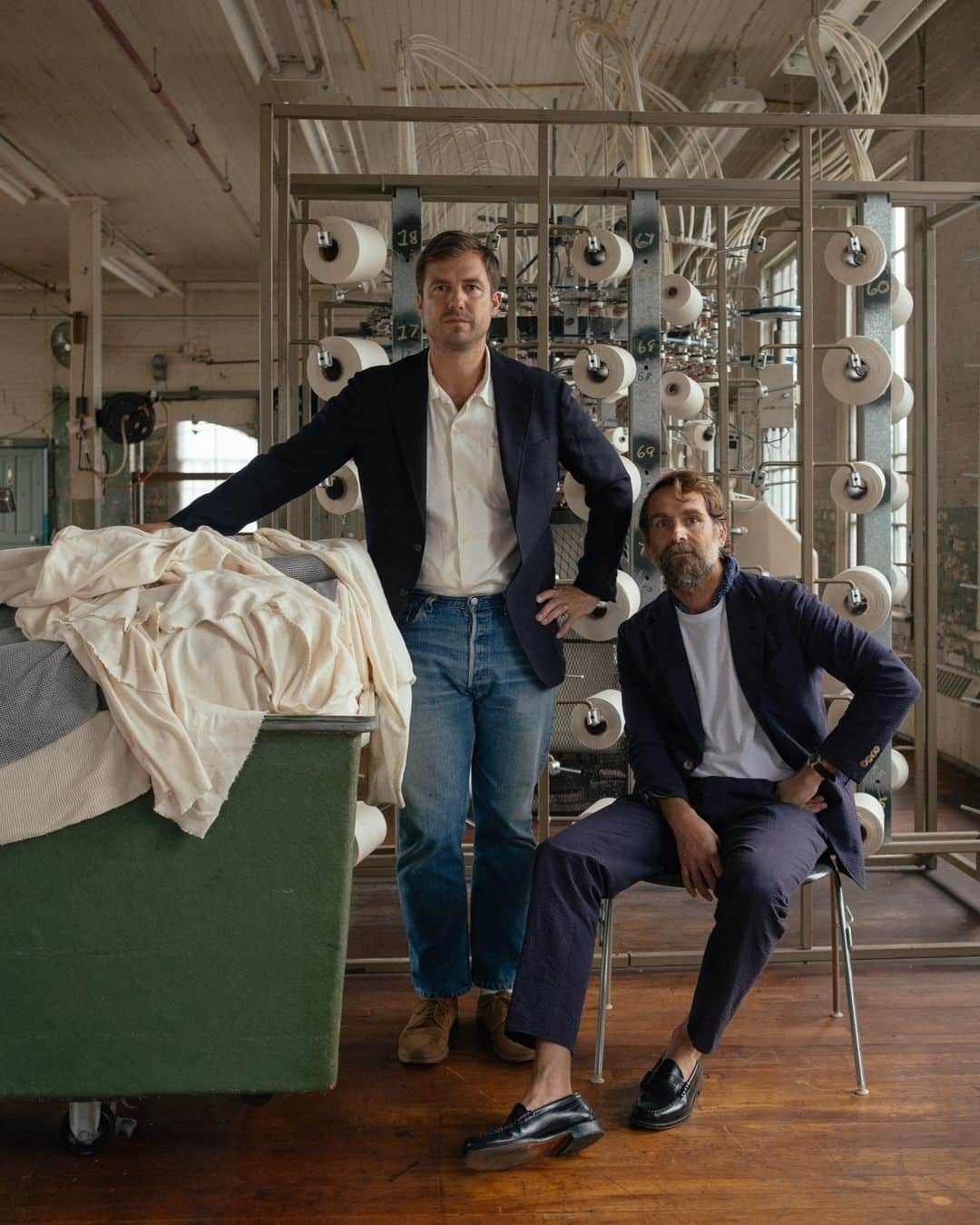 New York Times Fashionさんのインスタグラム写真 - (New York Times FashionInstagram)「Erik Allen Ford and Sasha Koehn started the label Buck Mason with a lofty goal: to make a superior T-shirt. They recently bought a sewing factory and cloth mill in Mohnton, Pennsylvania, where the brand now manufactures some of its most popular styles.  Over the past decade, the brand has grown to sell almost a dozen different short-sleeve T-shirts, along with other basics like jeans, sweatshirts and button-up shirts. Buck Mason touts its domestic manufacturing on its website, labeling some products as made in the U.S. and others as made with materials fabricated or grown in the country.  The founders had been looking into building a new factory in Texas, Ford said, when he got a call from a friend about the factory in Mohnton and its associated mill in neighboring Shillington. Both sites had been in and out of operation since they were opened in 1878 and in 1906.  Now they are owned by Buck Mason. At the factory, some employees are responsible for cutting and sewing T-shirts, while others iron them by hand or package them for shipping. About 10,000 T-shirts are made there a month, Ford said. “By fall, we aim to double the capacity,” he added. “The goal is to quadruple it.”  Take a look inside the Pennsylvania factory where @buckmason makes T-shirts at the link in our bio. Photos by @whereismyphd」8月29日 4時05分 - nytstyle