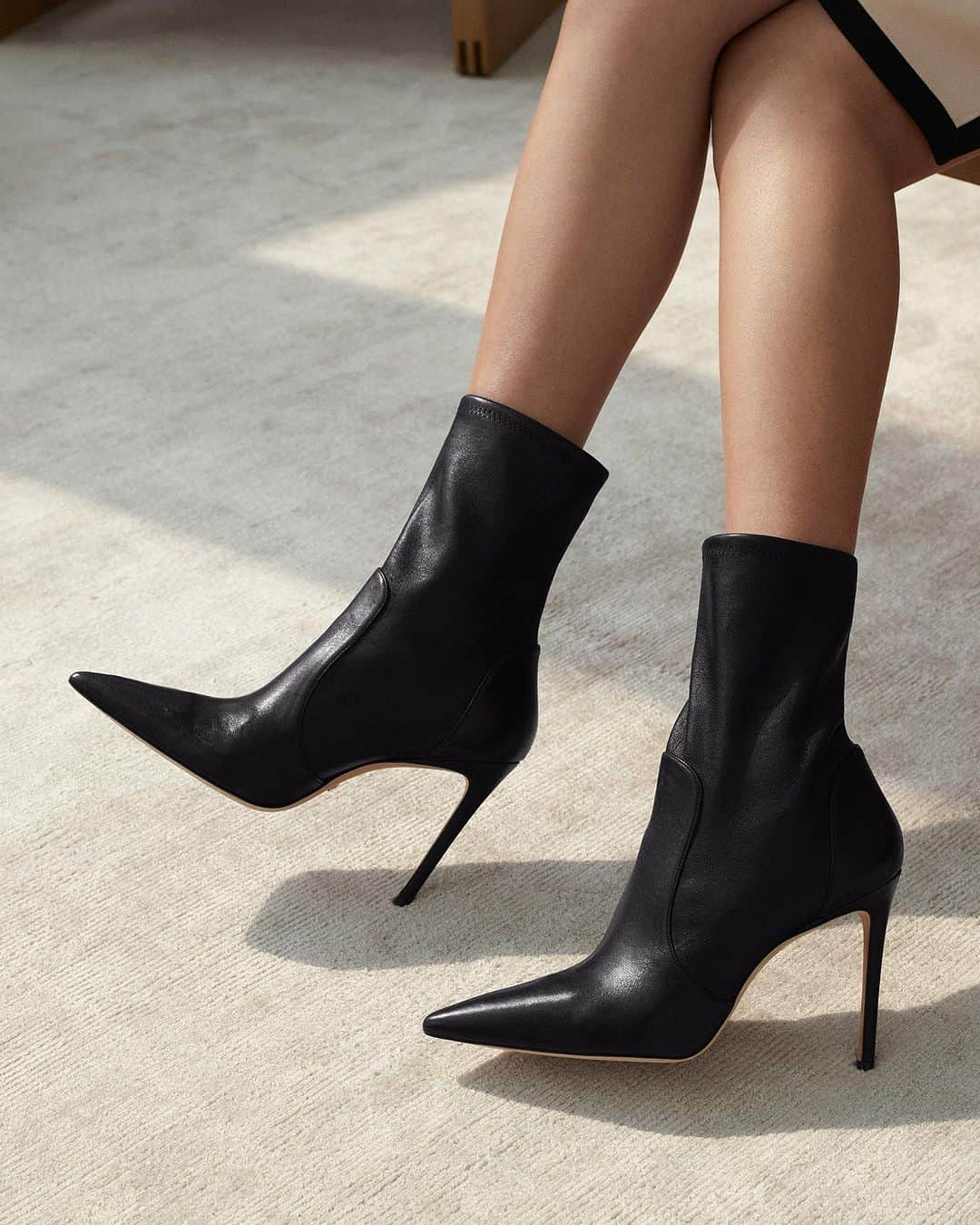 スチュアートワイツマンのインスタグラム：「Look sharp: Our signature STUART 100 BOOTIE is the dressy sock bootie your fall wardrobe needs. Crafted by SW artisans in Spain from innovative stretch-infused leather, it is constructed for a second-skin fit and further elevated by a 100-mm stiletto heel. Explore the Little Black Boots Capsule to find your favorite pair on stuartweitzman.com.​  ​  #StuartWeitzman #STUART」