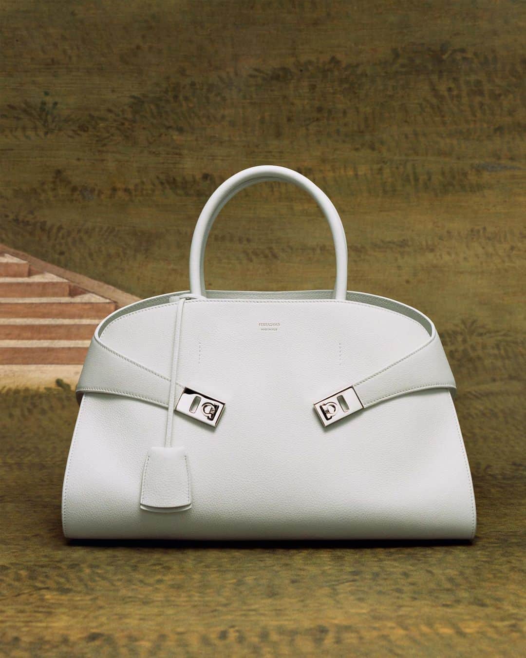 サルヴァトーレ・フェラガモのインスタグラム：「#FerragamoHugBag. Designed in Florence, and seen on a detail of Florentine master Francesco Granacci, 1515 ca., tempera on wood. By permission of the Ministry of Culture – Gallerie degli Uffizi, Firenze. #FerragamoFW23  Campaign Concept and Creative Direction @ferdinandoverderi Lensed by @tylersphotos」