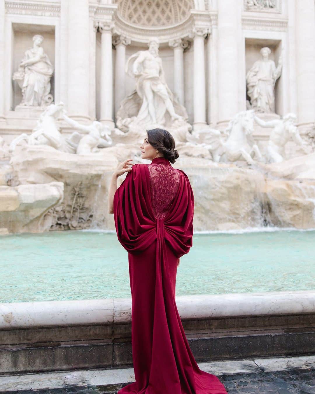 タダシショージのインスタグラム：「“In Rome, one had simply to sit still and feel.” – E.M. Forster  To Rome with Love. #fashioncampaign  Photography by @fotomagoria_com  #burgundydress #trevifountain #fontanaditrevi #summerinrome #celloplayer #newfashioncampaign」