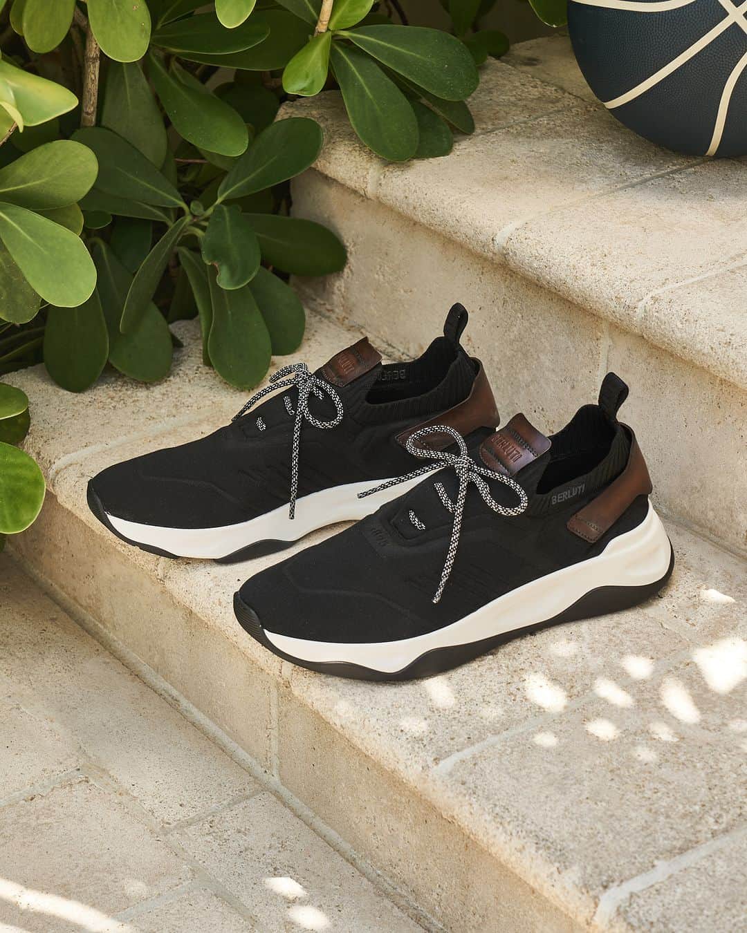 ベルルッティのインスタグラム：「- THE SHOE: SHADOW BY #BERLUTI -   Texture play and a 3D effect are where it’s at when it comes to Shadow’s newest version. For Fall 2023, the emblematic Berluti sneaker takes on a soft-touch fabric knitted in high frequency to achieve a distinctive three-dimensional volume that contrasts with its pure lines and its smooth bicolour outsole.   Now available online and in-store.   Photography by @chauntevaughn   #BERLUTIFALL2023」