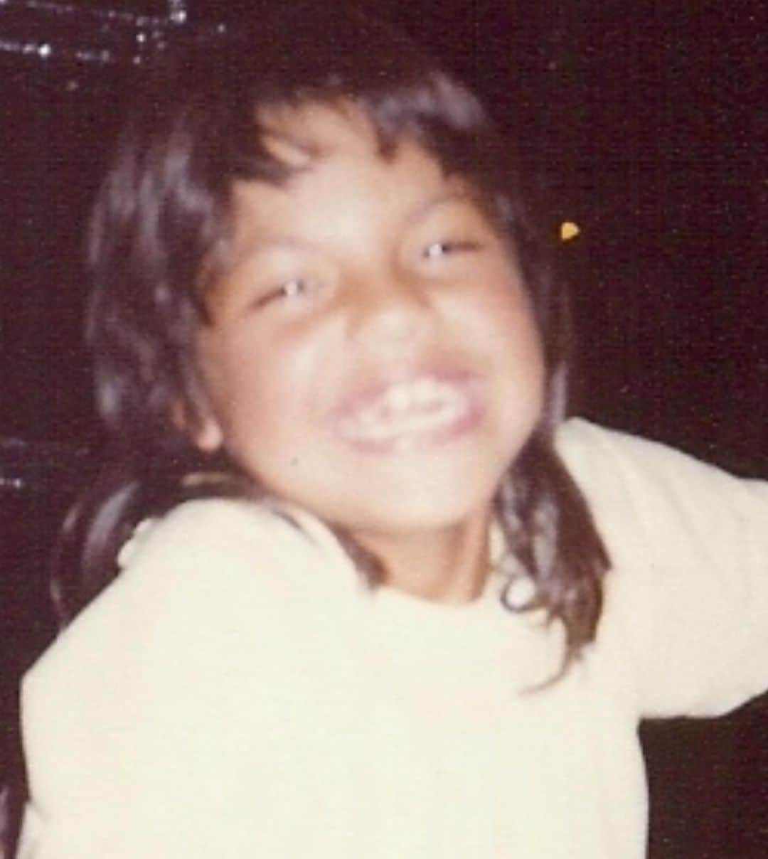 サラ・ラミレスのインスタグラム：「Pic of Sara, at around 8 years old, wearing a light yellow shirt, a huge smile, and an early 80s mullet.   Second pic is of 2 books; Sara’s extra flowery “This is the Story of” baby book open to the Baby’s Arrival page with birthday info, and the very serious looking Fathers Labor Coaching Log and Review Book because 1975.   There is so much to say but I’m gonna keep it simple. You’re welcome.  Happy birthday to me! May this kid continue to feel and know that they are loved beyond their gender, they are valued beyond their productivity, and they will always be held and protected by this softening blossoming adult who may or may not be bringing their killer mullet back.」