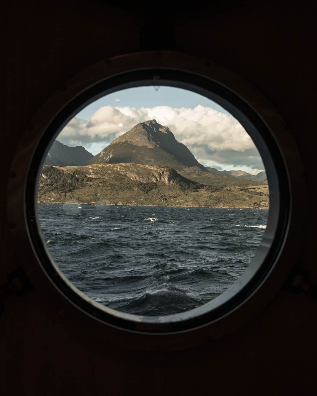 National Geographic Travelさんのインスタグラム写真 - (National Geographic TravelInstagram)「Photo by @gretarybus | The dramatic landscape of South America's Tierra del Fuego viewed from a porthole.   Follow Maine-based photojournalist @gretarybus for stories about human connections to the natural world.」9月1日 1時30分 - natgeotravel