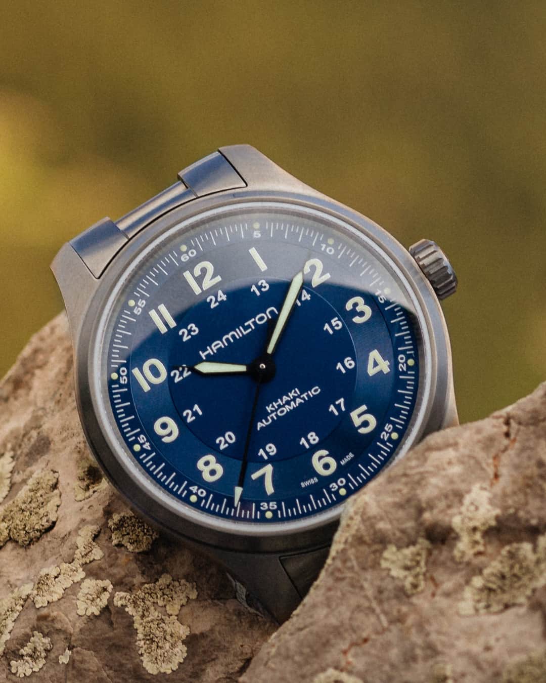 Hamilton Watchのインスタグラム：「Embrace the journey of life on your wrist.  Opt for our adventure-ready Khaki Field Titanium 42mm boasting a brushed titanium case and bracelet, accentuated by a deep blue bi-tonal dial.  #hamiltonwatch #new #watch #watchoftheday  (Ref. H70545140)」