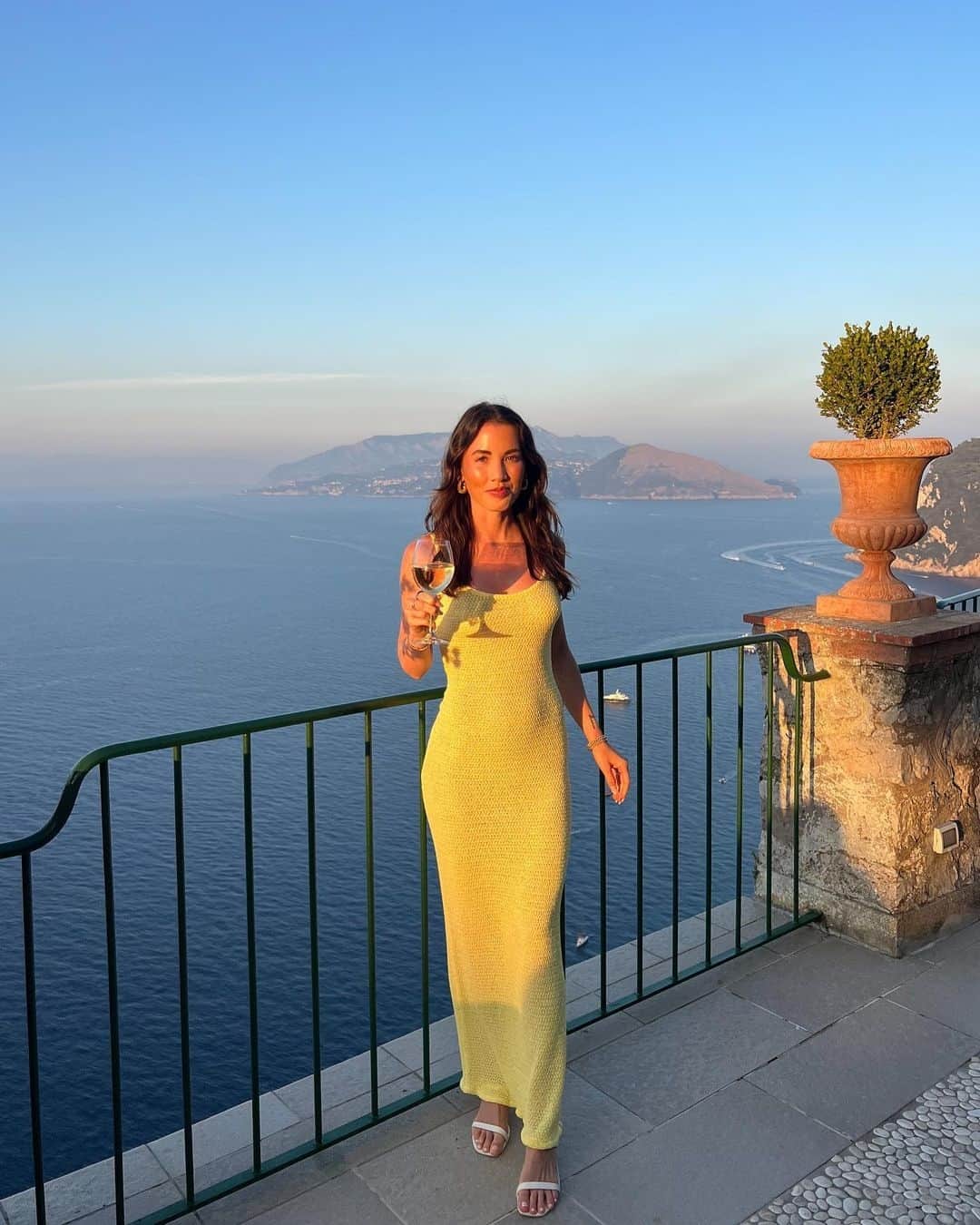 Beginning Boutiqueのインスタグラム：「A golden hour moment for @paigeronelle while vacationing in Capri in our most-loved Ezra Yellow Maxi Dress 💛」