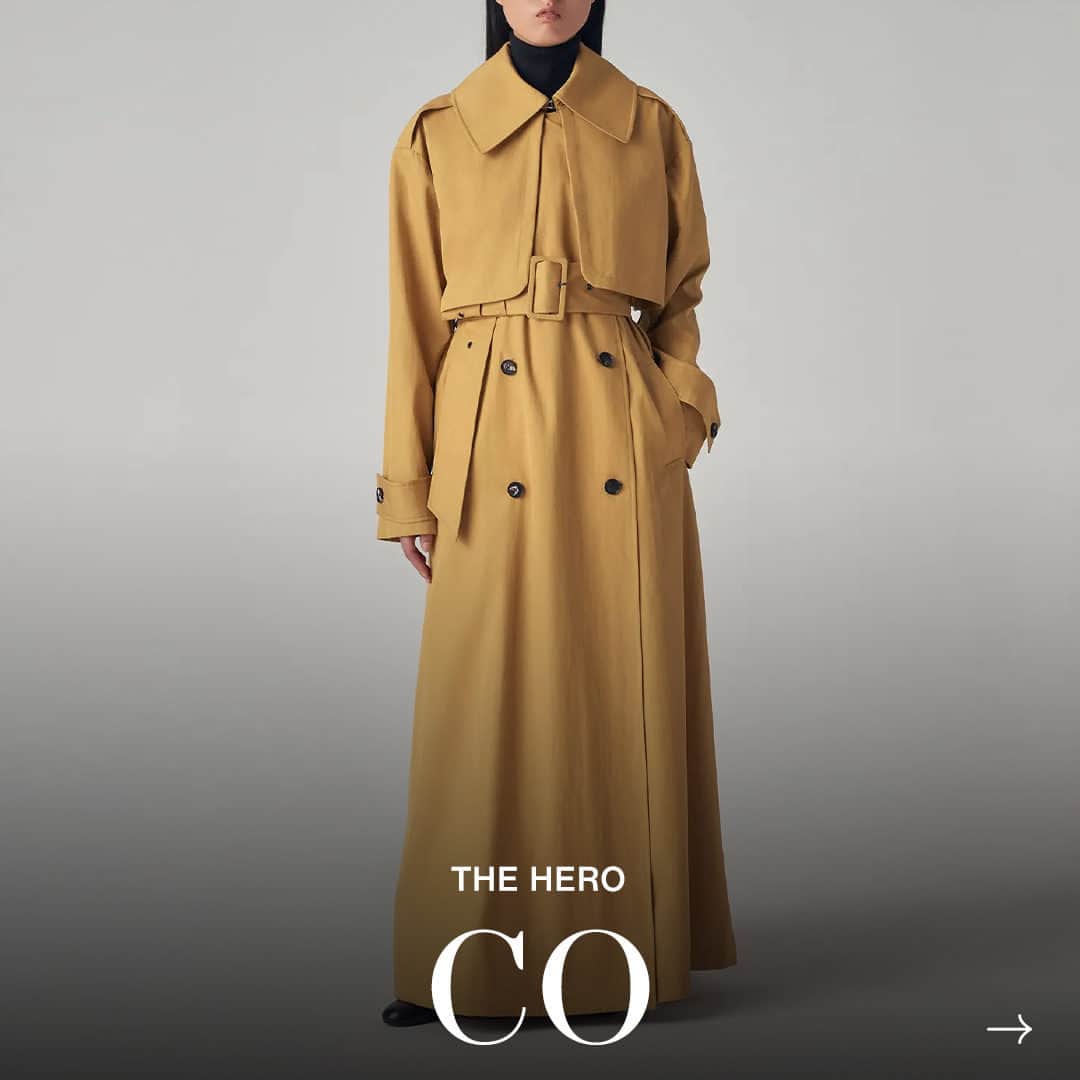 ShopBAZAARのインスタグラム：「One of the hands-down, undisputed must-haves every closet should star is the trench coat, and our Hero from @co is the ultimate must-have. The buzzy brand known for its minimal aesthetic is giving this classic favorite a new spin with an extra-long, floor-grazing length, subtle mustard hue, oversized buckle, and relaxed paneling. Impeccably crafted and thoughtfully designed, this piece will steal the spotlight. #SHOPBAZAAR」