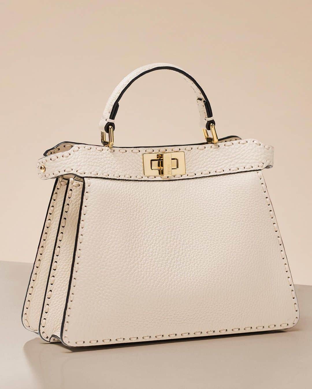 Fendiのインスタグラム：「The Maison's signature Selleria stitching adorns a timeless iteration of the #FendiPeekaboo in Cuoio Romano leather, while Interlace weaving shows a new expression of Fendi craftsmanship.」